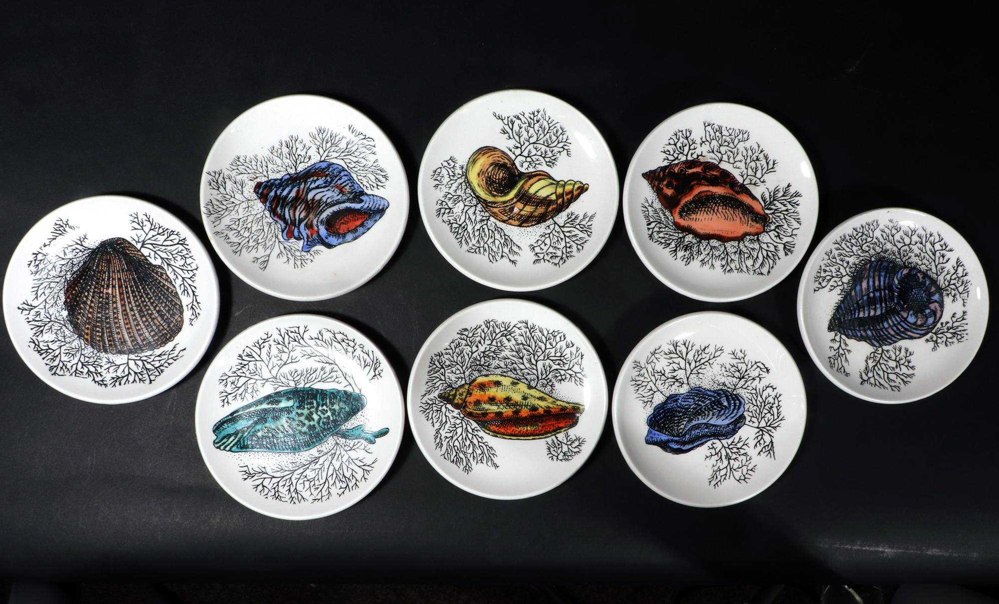 Mid-century Modern Ceramic Coasters decorated with Sea Shells,
Possibly Bucciarelli,
1960s.

The complete set of eight coasters are each decorated with a different colored sea shell amongst black seaweed.

Dimensions: 4 1/8 inches wide x 1/2 inch