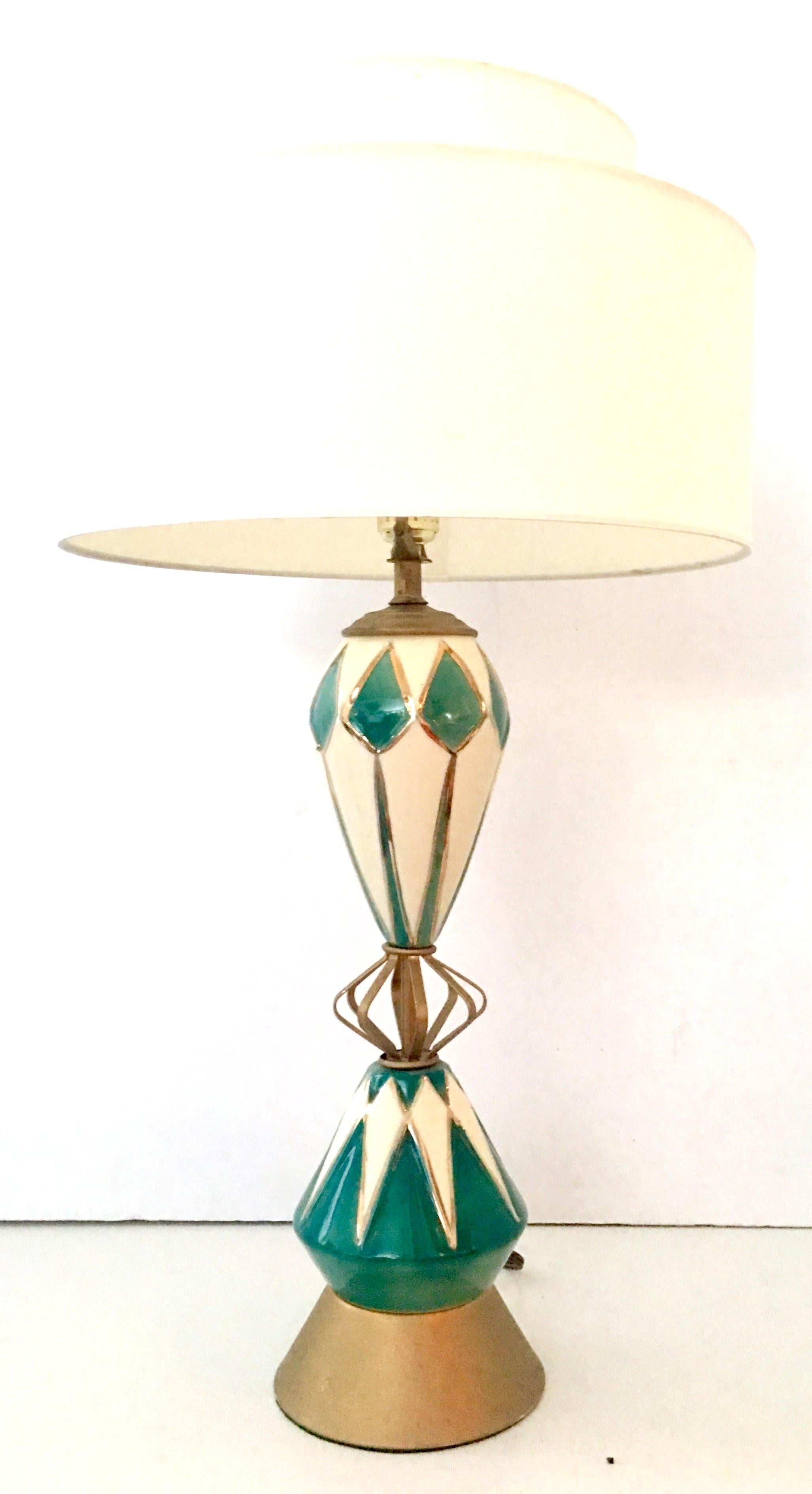 Quintessential Mid-Century Modern Atomic Sputnik ceramic glaze and brass table lamp. Features a teal green , off-white 