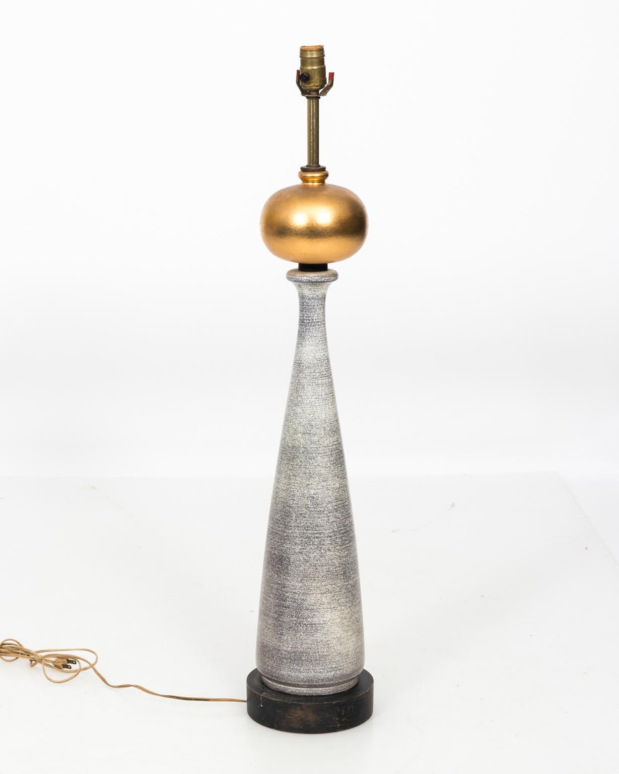 Modern style ceramic base lamp with gold globe on wood base, circa mid-20th century. This lamp also features a new black shade.
