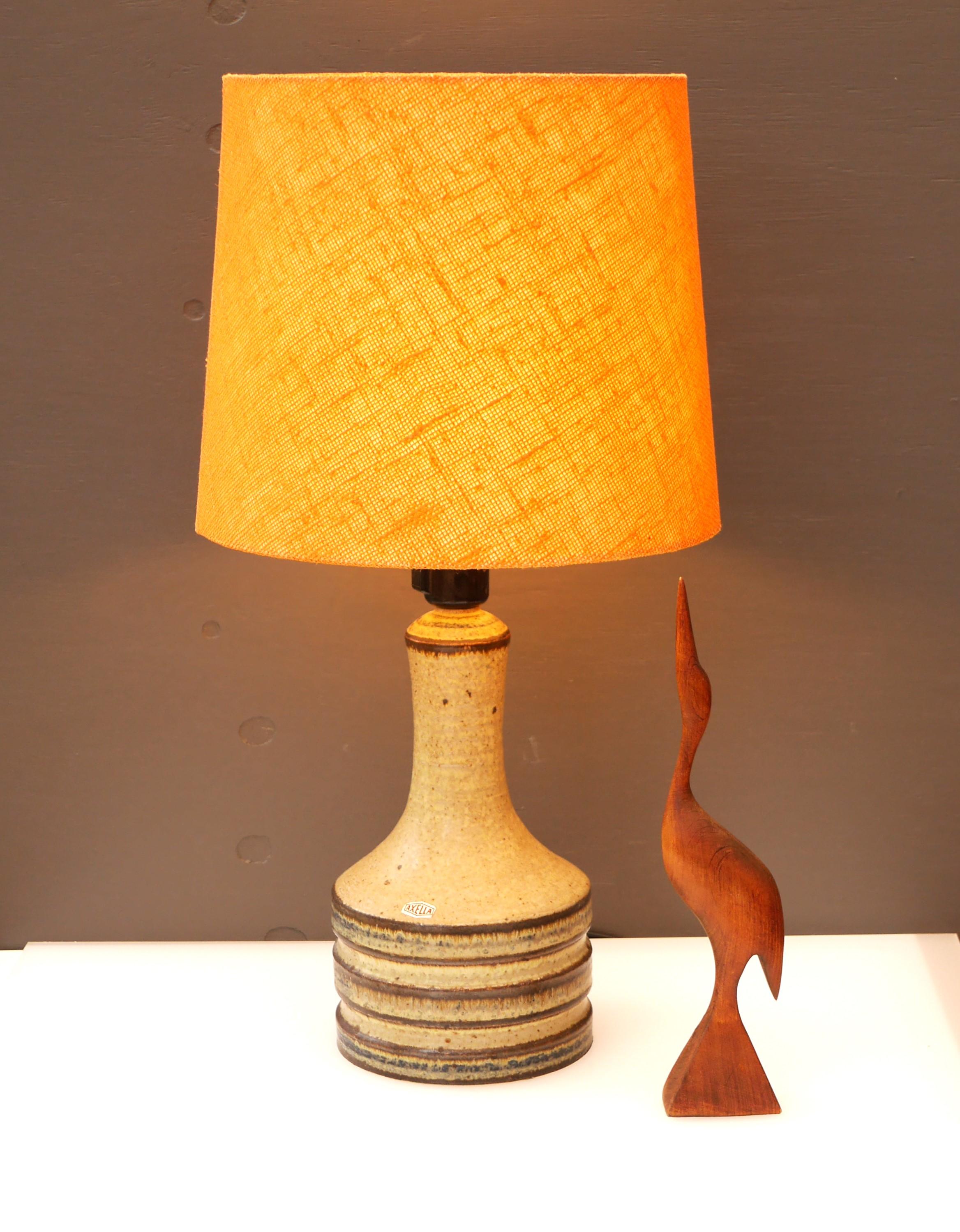 
A rather large and substantial handmade ceramic stoneware lamp base made by Axella, Denmark. It has a 70s Mid-century modern feeling to it, yet still is this lamp classic with a timeless feeling. The lamp is very elegant and sophisticated, and it