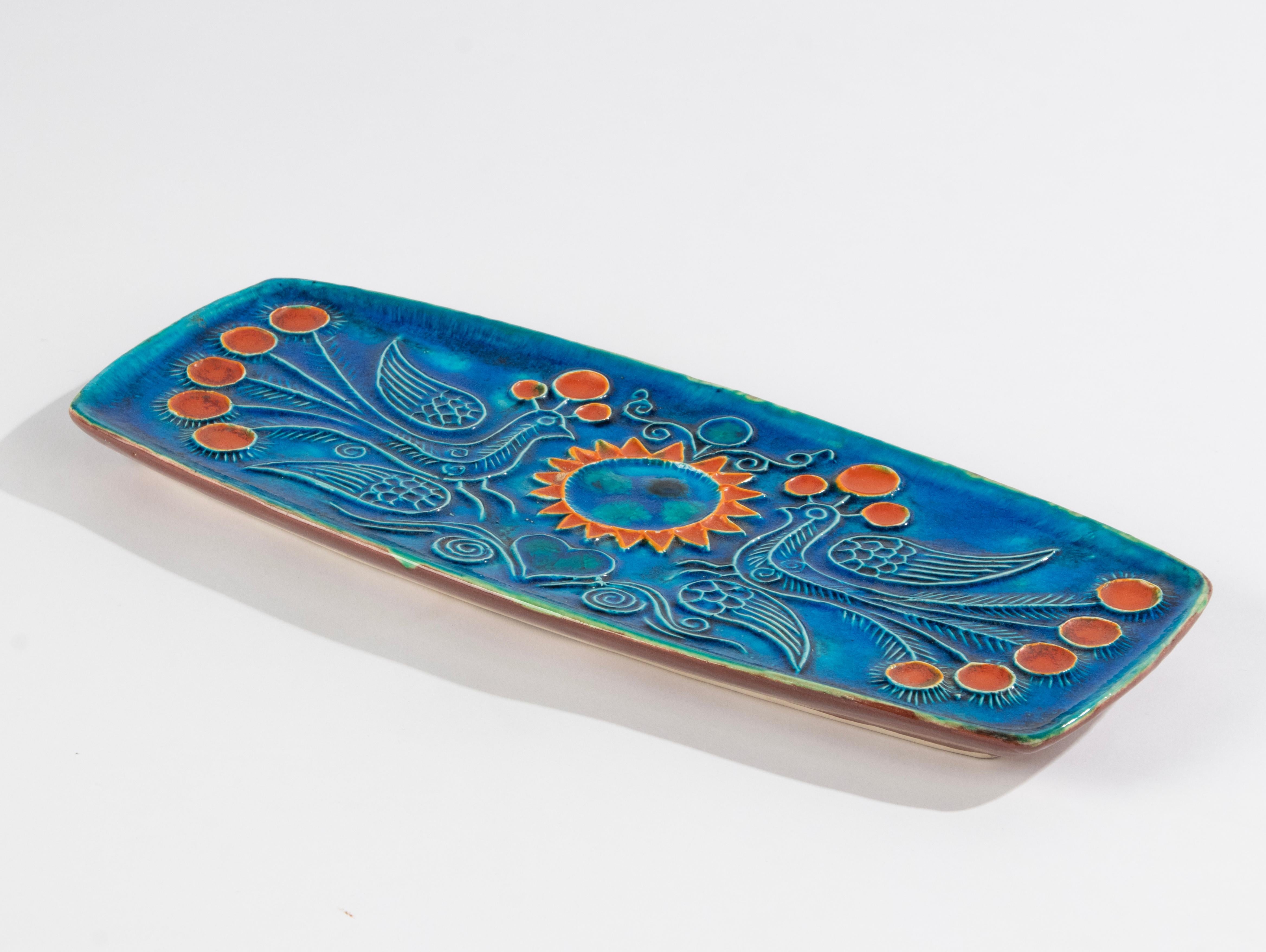 Un beau plat de service en céramique, réalisé par Jean Claude Taburet (1926-2013) pour la marque française Quimper. Le plat de service est en très bon état. Il n'y a pas d'ébréchures ni de lignes de démarcation. 
Signé au dos. 

Dimensions : 36 x 15