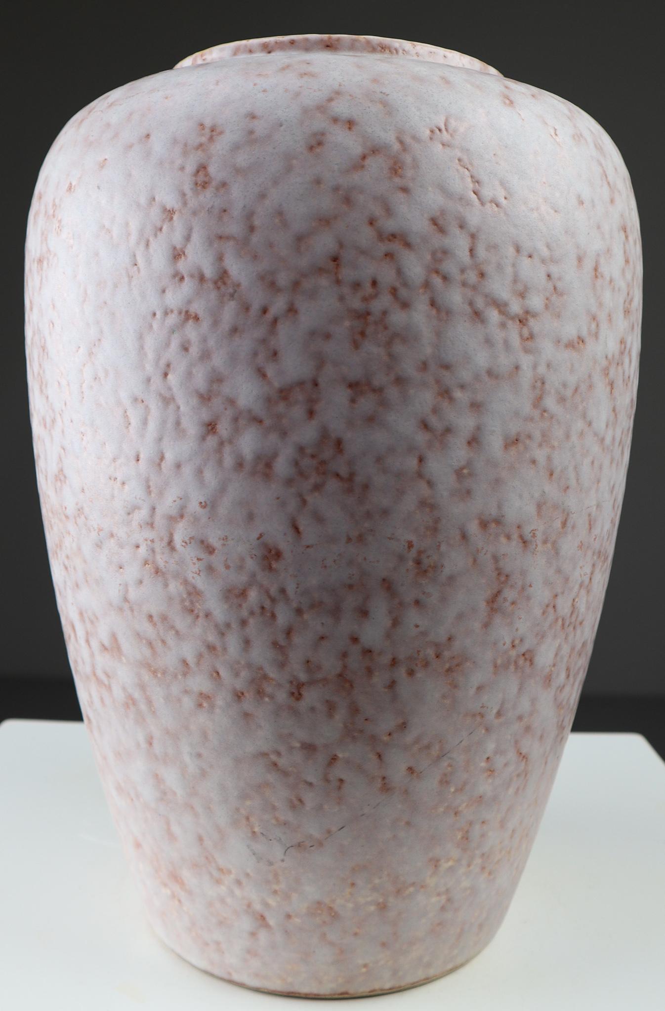 Modern Austrian ceramic vase has a gorgeous interior glaze of light yellow/cream. The vase has a abstract pattern in a white/old pink color. The vase is marked with the production number No: 239-30 and land of production Austria. In very good