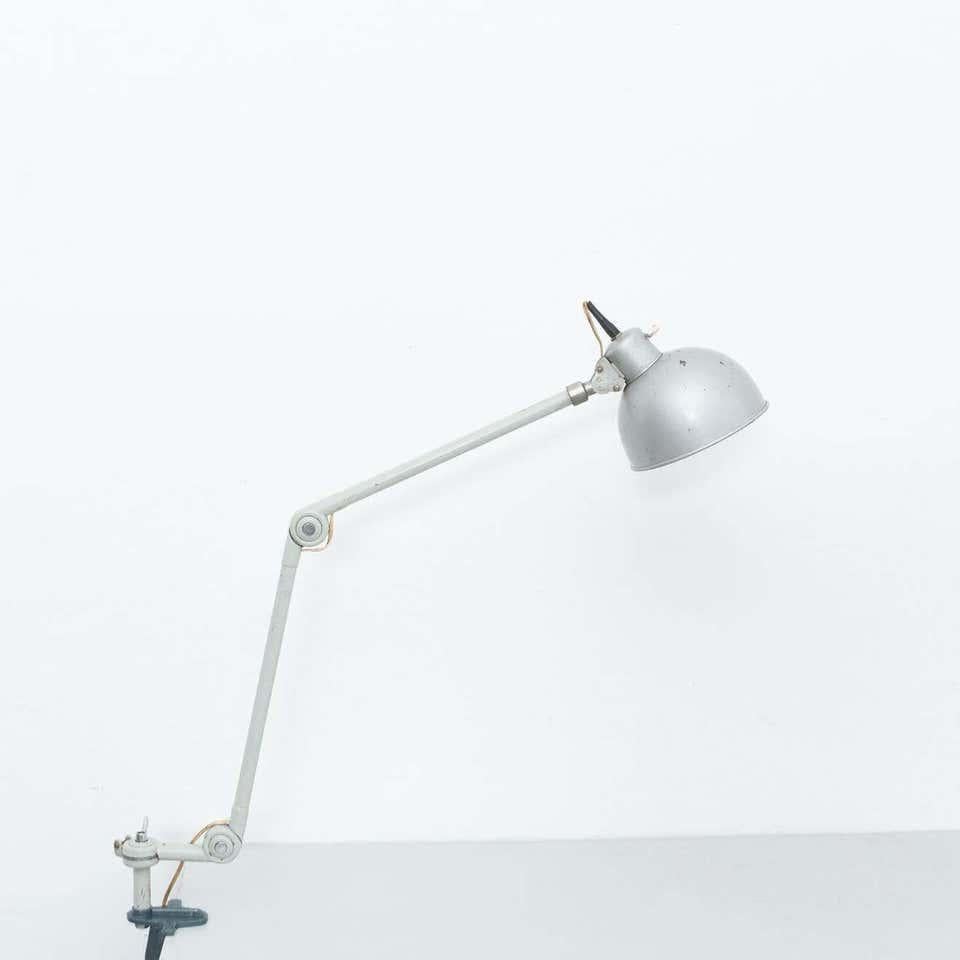 Mid-Century Modern table lamp. By unknown manufacturer from France, circa 1960.  In original condition, with minor wear consistent with age and use, preserving a beautiful patina.  Material: Metal  Dimensions: D 15 cm x W 92 cm x H 100 cm.
