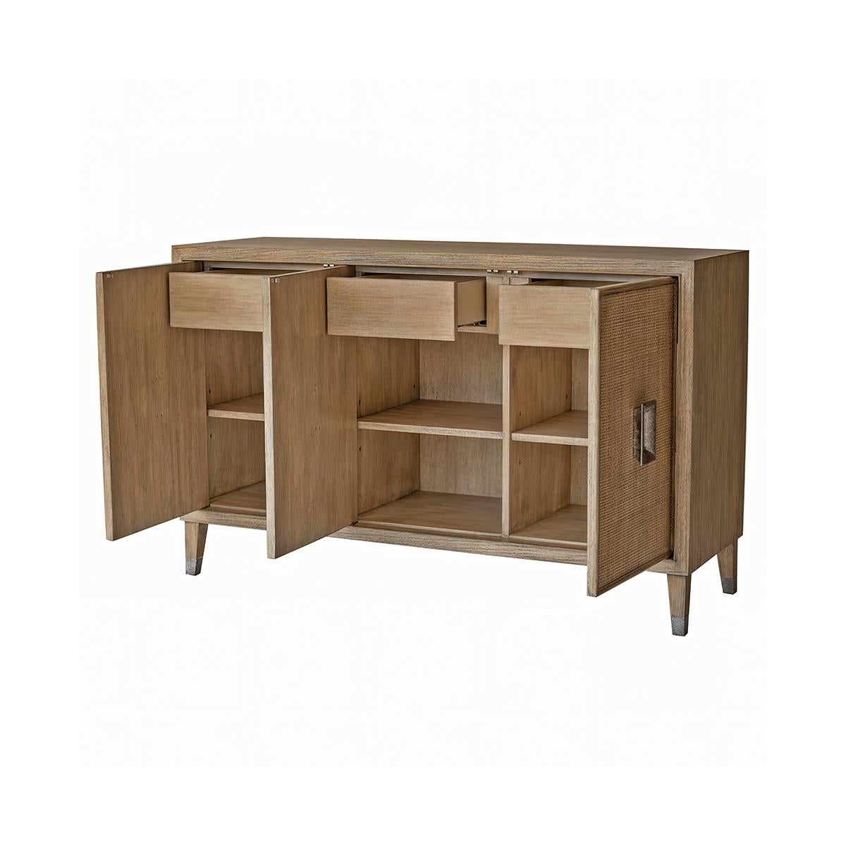 Mid-Century Modern Cerused Credenza. The three-door credenza has a neutral cerused hand finish, with wire brush texture and grey subtle highlights to the Celtis woods.

With three doors that open to reveal a fitted interior of three drawers and