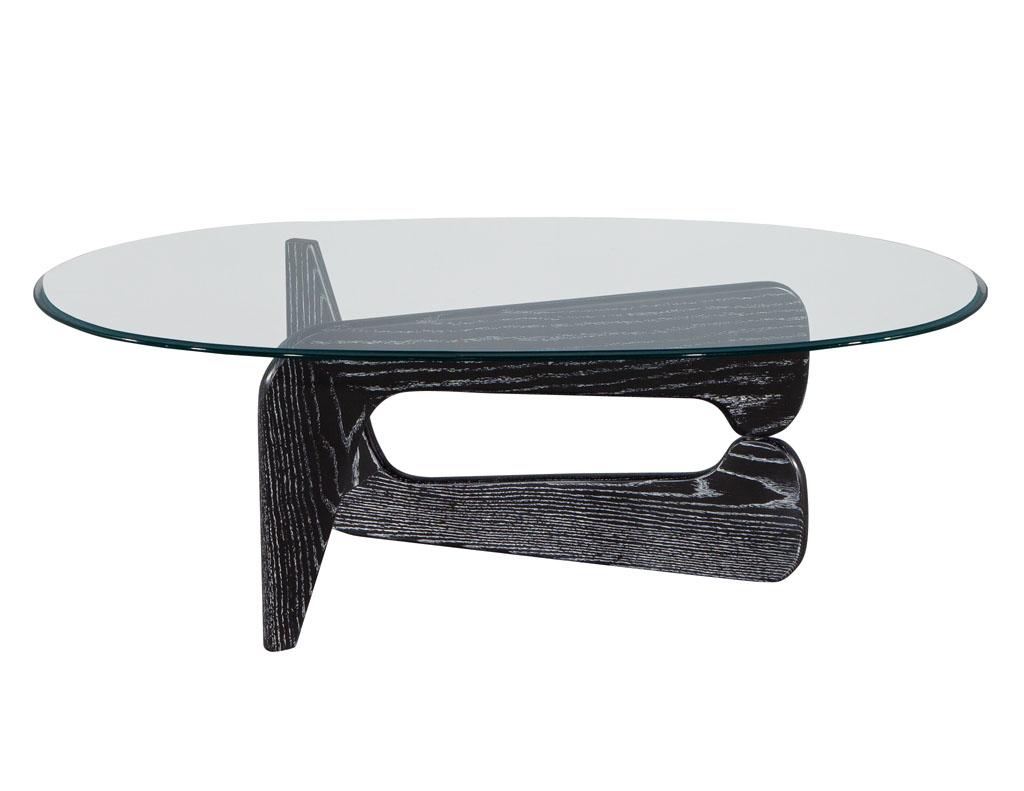 Mid-Century Modern Cerused Oak cocktail table in the Style of Noguchi. American, circa 1970’s Mid-Century design, in the style of iconic designer Noguchi. Newly refinished in a 2-tone black and white cerused oak finish. Original glass top with