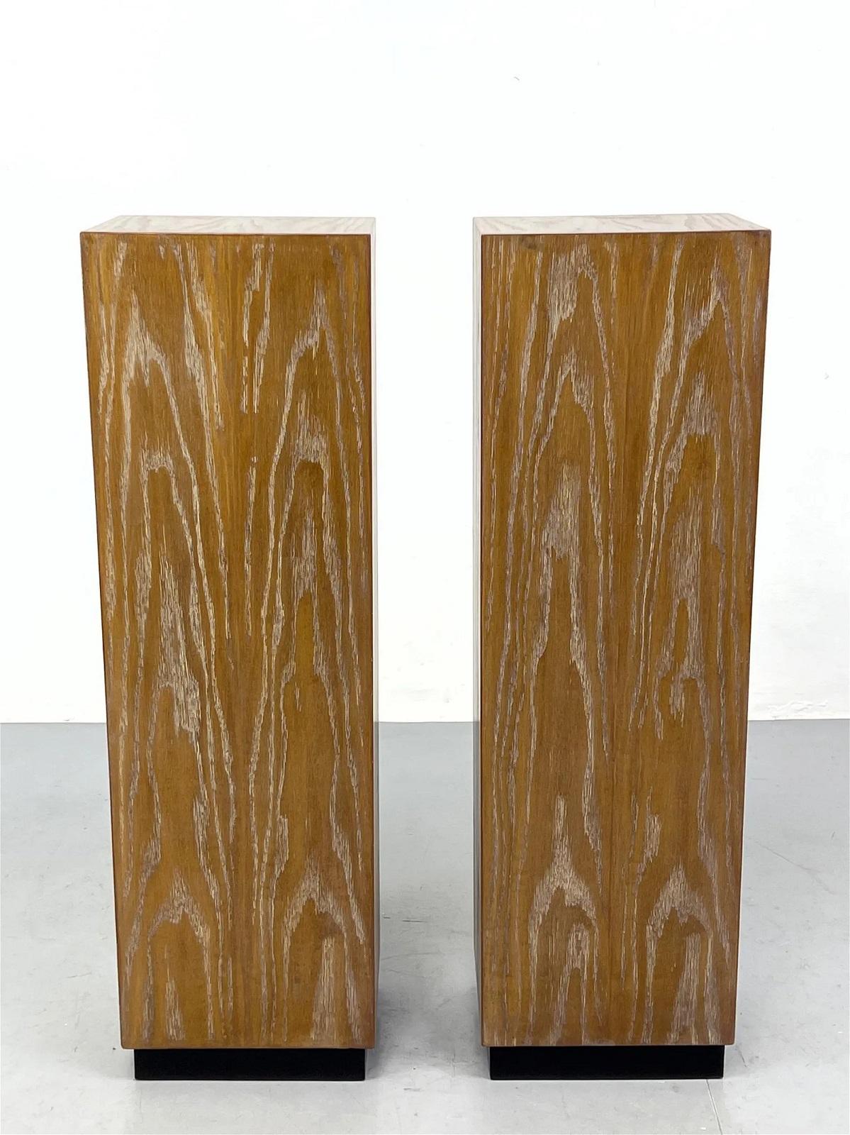 Pair of Mid-Century Modern cerused oak pedestals. Each pedestal has black lacquered bases.