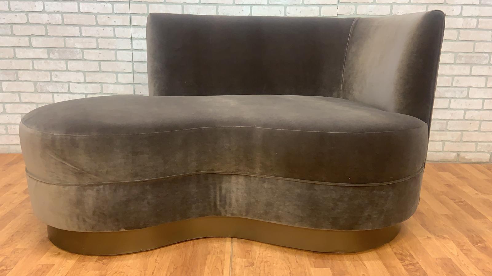 Vintage Mid Century Modern Chaise Newly Reupholstered in Grey Velvet on a Bronze Base

This vintage Mid Century Modern Chaise is a striking piece of furniture that combines the iconic design elements of the mid-century era with modern