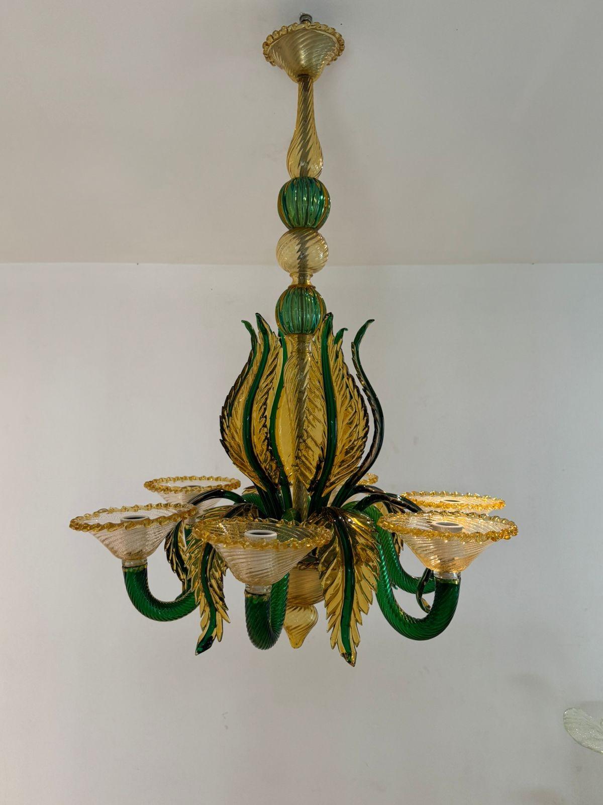 Beautiful Mid Century Modern, hand blown Murano glass chandelier alluding to a garden with its green and yellow leaves.
This chandelier is masterfully done in yellow, green, clear and 24k gold included Murano glass, and shows several techniques that