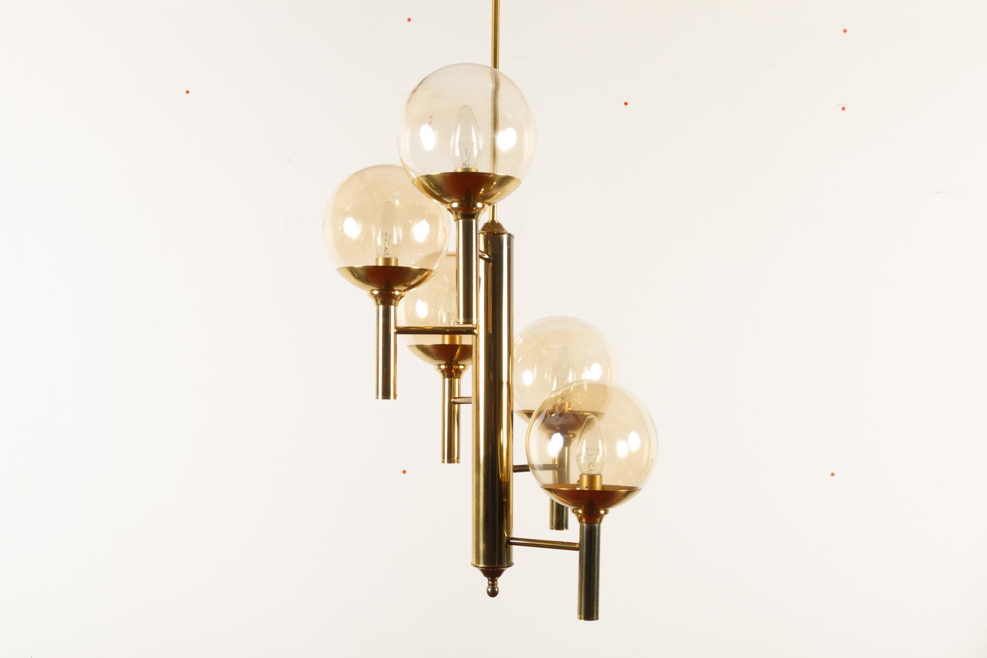 Mid-Century Modern chandelier by Svend Mejlstrøm for Mejlstrøm Belysning, 1960s.
Five armed vintage chandelier in brass with five smoked glass orbs. Arms are mounted around a central brass pillar in a spiral stair pattern. Emits a soft warm light