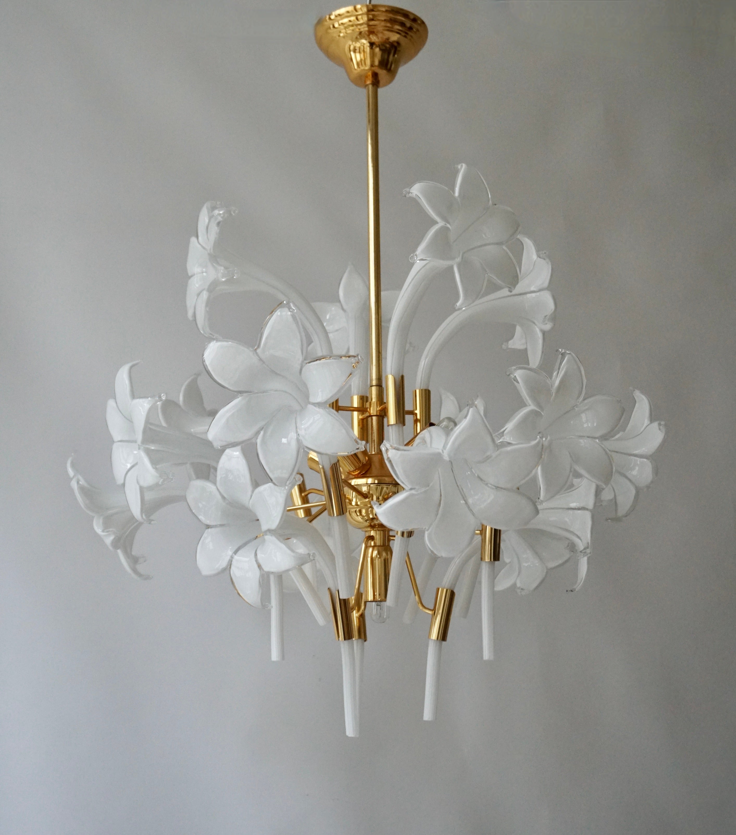 A beautiful Italian hanging lamp chandelier. 
The lamp is attributed to Franco Luce. The glass flowers and leaves are mouth-blown and hand-formed. 
The light consists of of a golden metal base with white flowers. 
 
Dimensions: Diameter 23.6