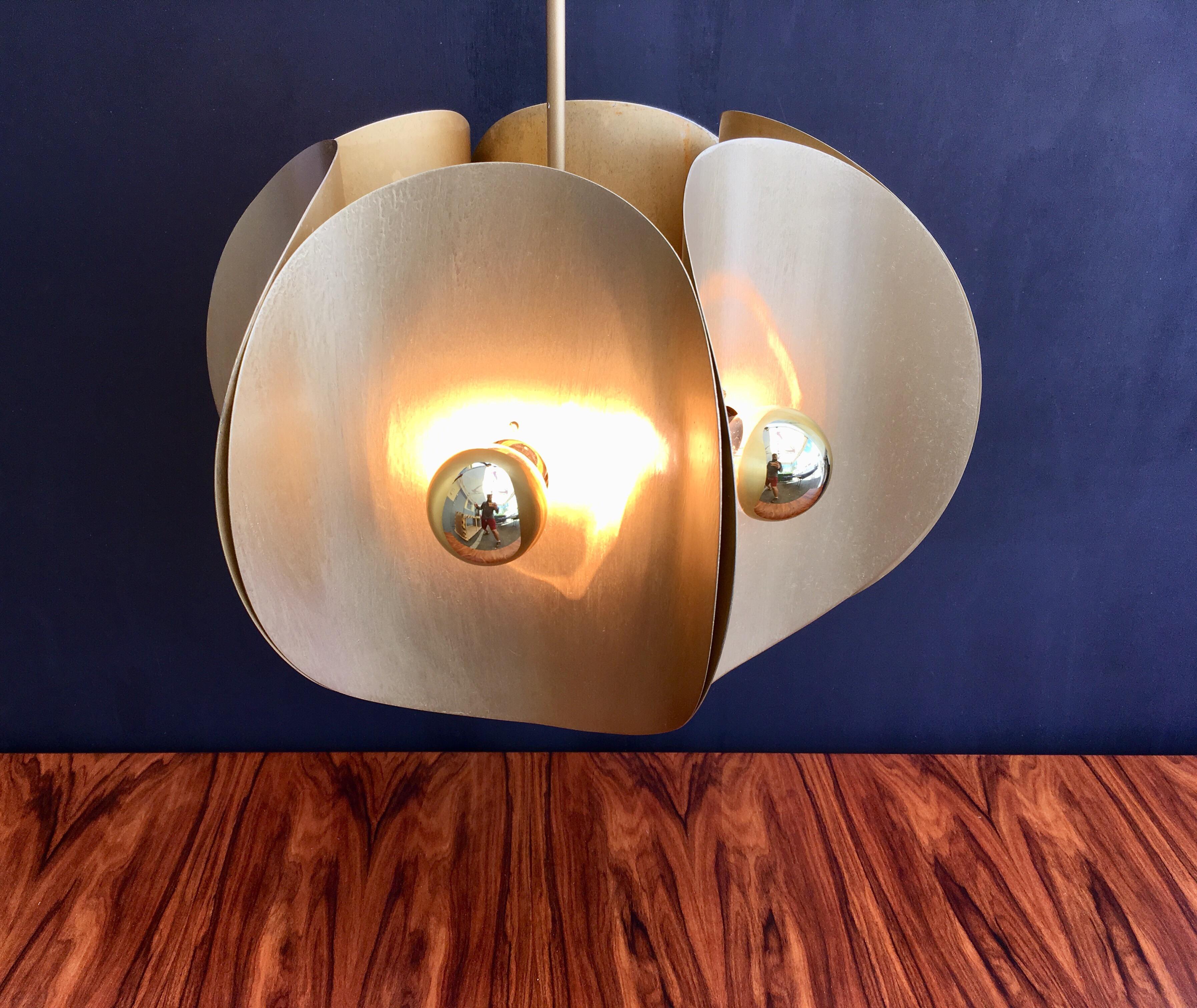 Chandelier has six crescent shaped sides with six sockets, cool Mid-Century Modern design. Metal has gold finish.