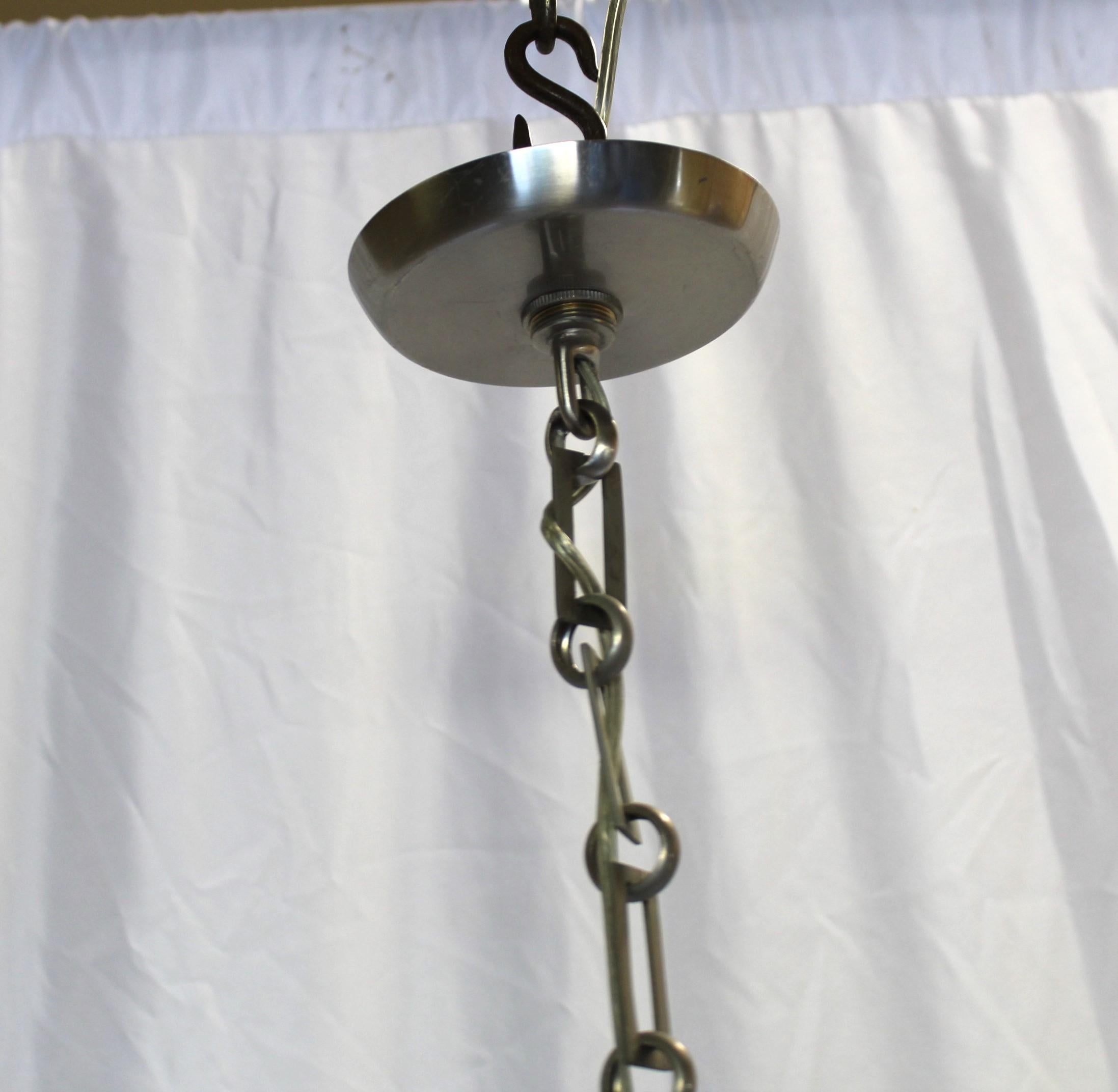 A custom designed smaller size all metal chandelier that could be used in an entry way or bathroom. This is the showroom sample and never used. Has been in storage. Total drop is at 36
