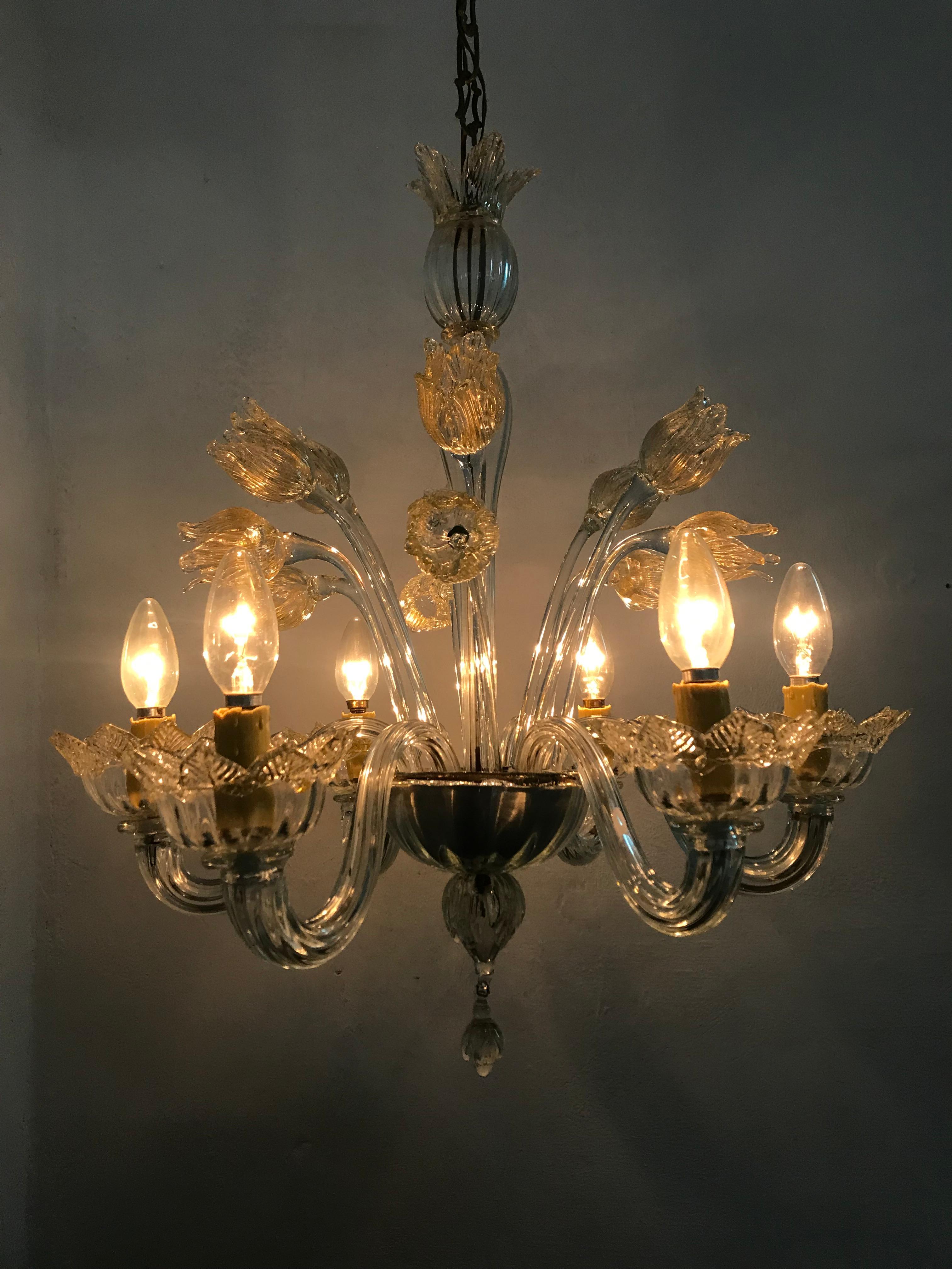 Mid century six light chandelier manufactured in clear Murano glass with gold inclusions, the manufacture of this chandelier is attributed to Barovier e Toso and is also very similiar to Andre Arbus' Designs, circa 1950.