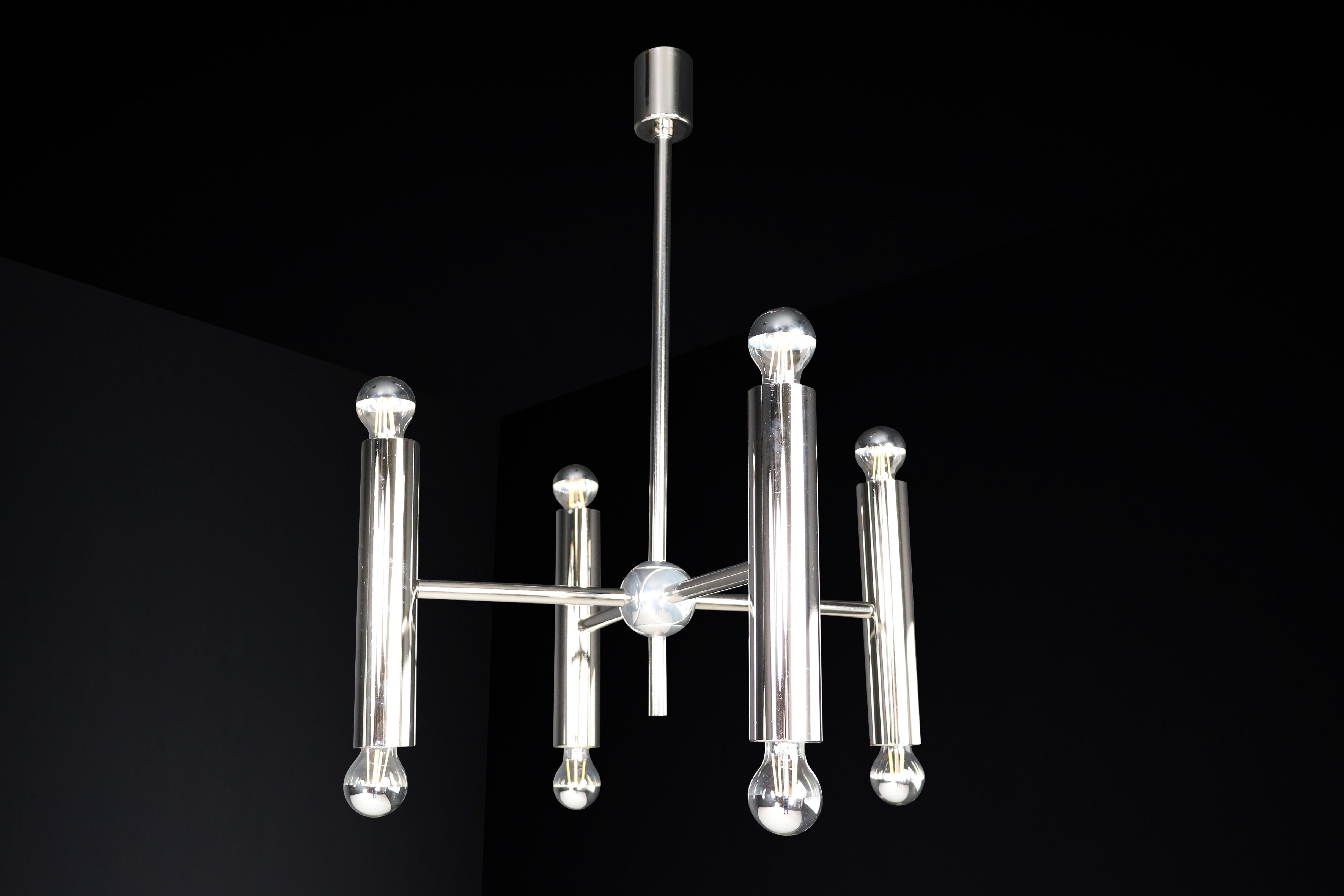 Mid-Century Modern chandelier in polished steel with eight lights, made in Germany in the 1960s.

This is a stunning midcentury chandelier from Germany, made in the 1960s. It boasts a polished steel frame and four tubes held together by steel. Each