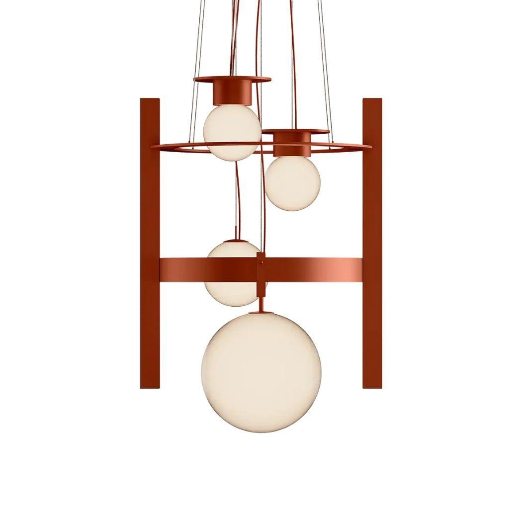Yala Suspension Lamp in red-brown lacquer, showcasing four spheres suspended in an enchanting arrangement. Elevate your interior with its dynamic interplay of shapes and levels, infusing your decor with a contemporary touch of sophistication.
Yala