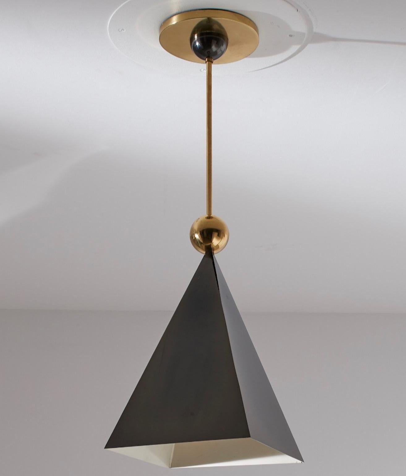Luca Scacchetti, mod. PRIMA LUNA Chandelier in brass and burnished metal manufactured by BOTTEGA GADDA  in Milano
The burnished metal reflector has the pyramid-shaped that combines well with the brass sphere and the upper half sphere, recalling