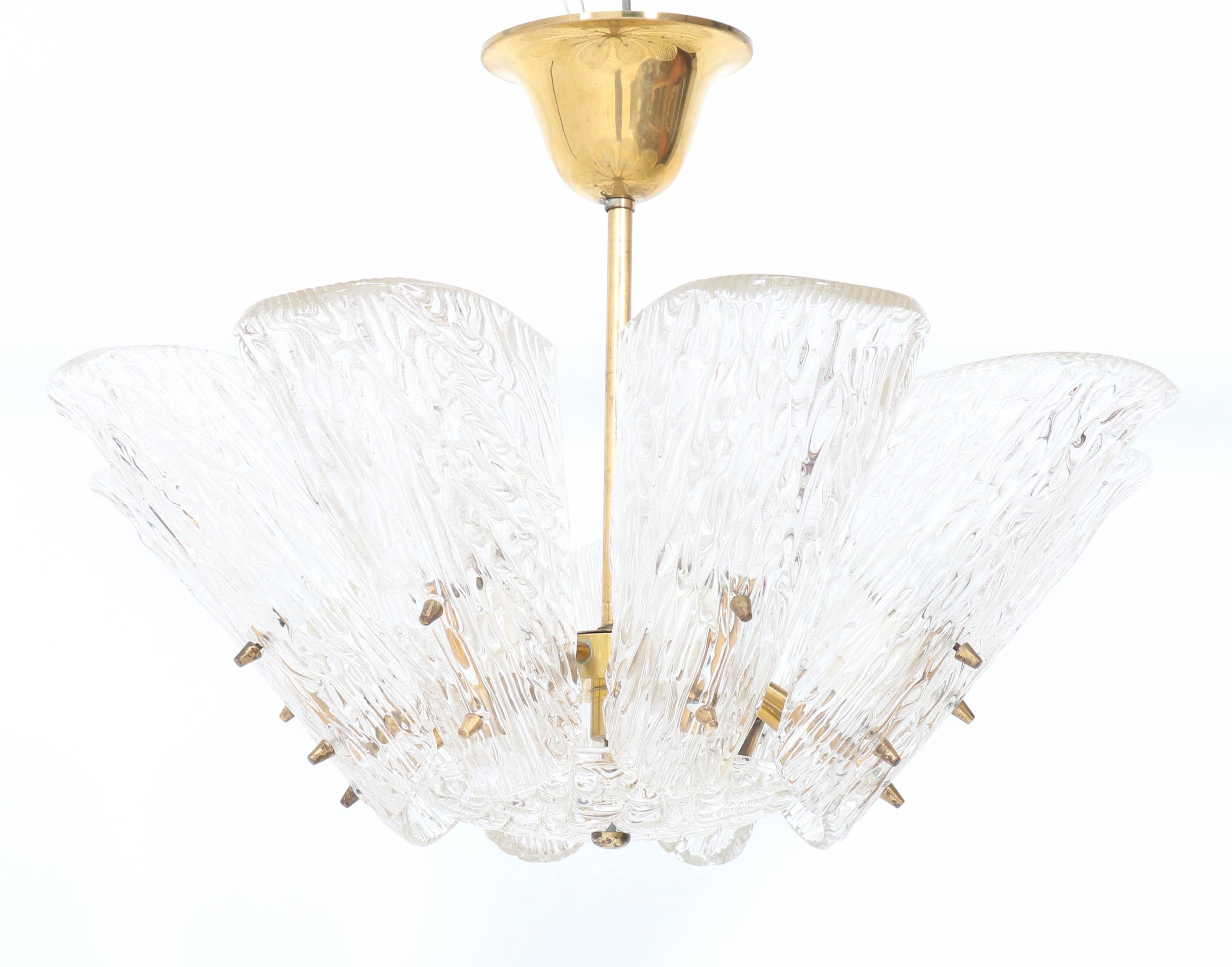 Magnificent Mid-Century Modern chandelier.
Design by J.T. Kalmar.
Striking Austrian design from the 1950s.
Brass frame with eight original ice glass shades.
Rewired with eight original sockets for E-14 light bulbs.
In very good condition with a