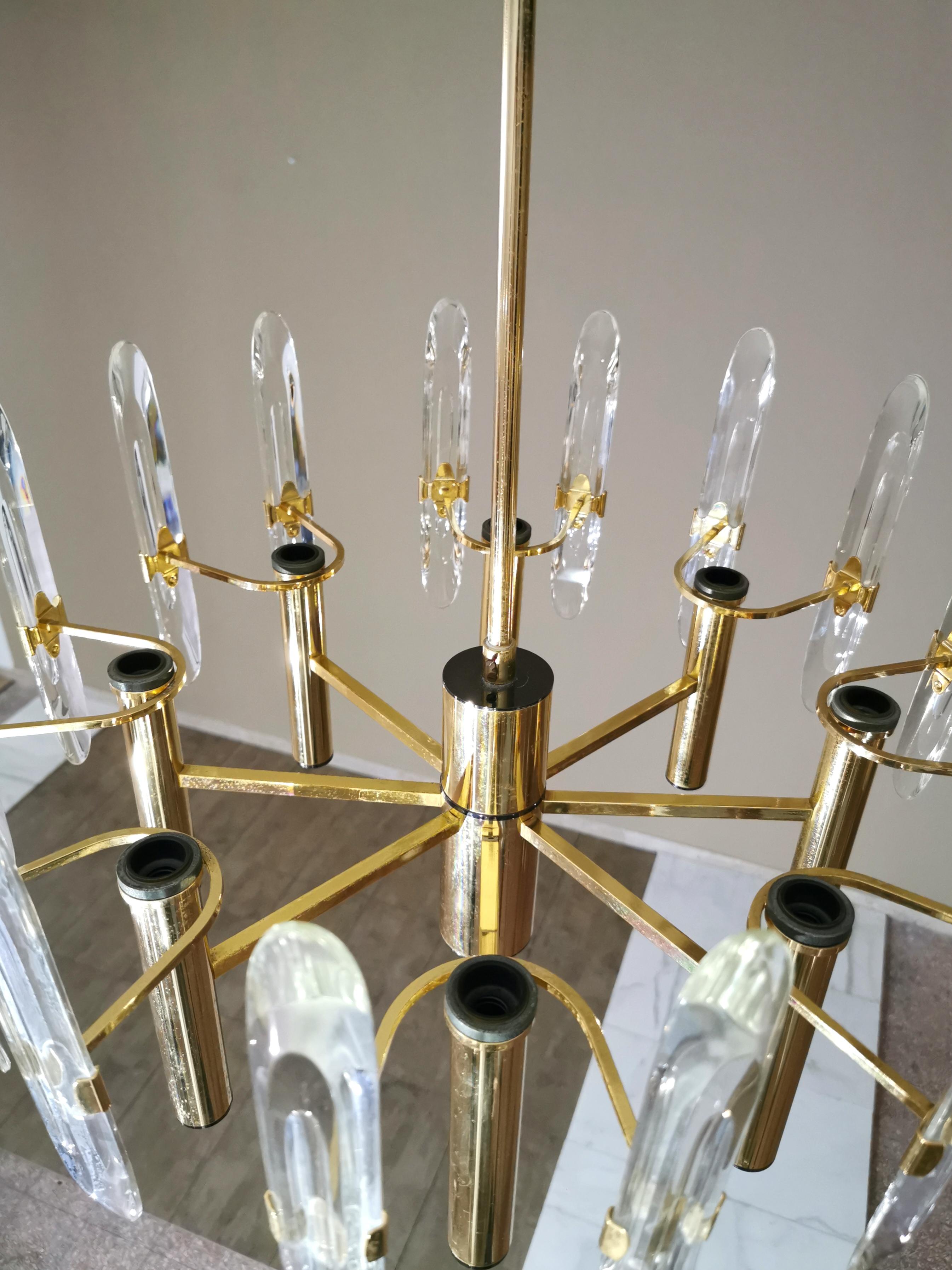 Set of 2 elegant chandeliers by the Italian designer Gaetano Sciolari. each single chandelier with 8 lights and 16 beveled crystal prism glasses in total. Contains 8 candelabra decorated with two glasses in the shape of ellipses. Structure in