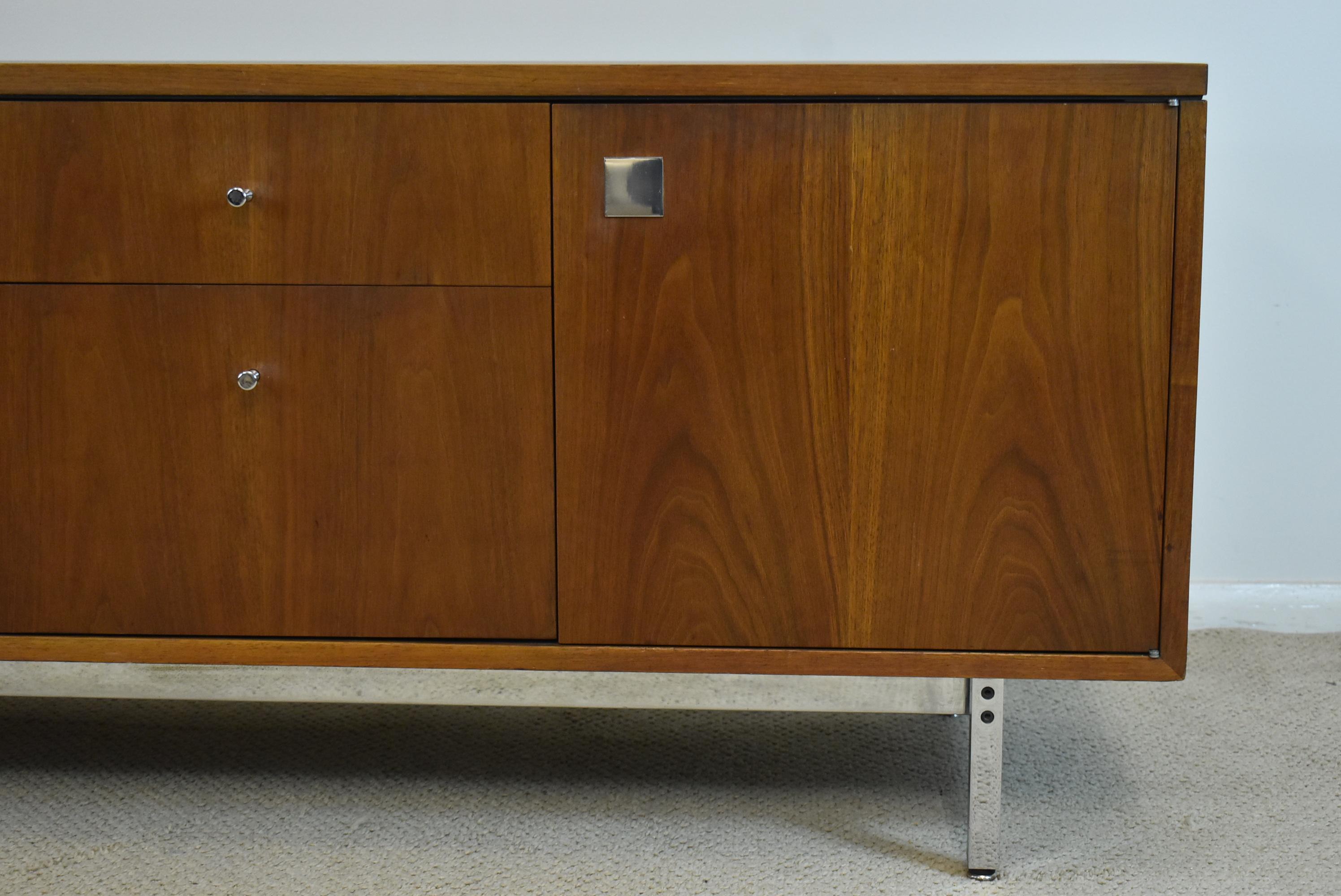 Mid Century Modern Charles Eames for Herman Miller walnut credenza. Chrome square tubular frame and legs. Two doors and four drawers. Drawers have hidden inside key locks. File cabinet. Very nice condition. Holes have been drilled in the bottom of
