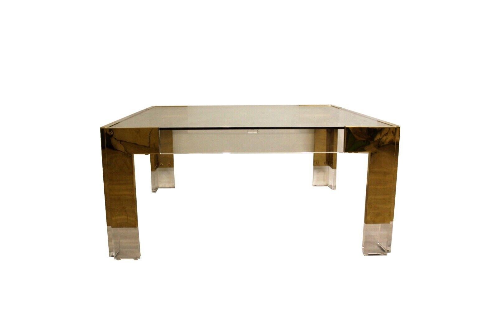 Le Shoppe Too presents this beautiful lucite, glass and brass square coffee table attributed to Charles Hollis jones. In good condition. Dimensions: 36