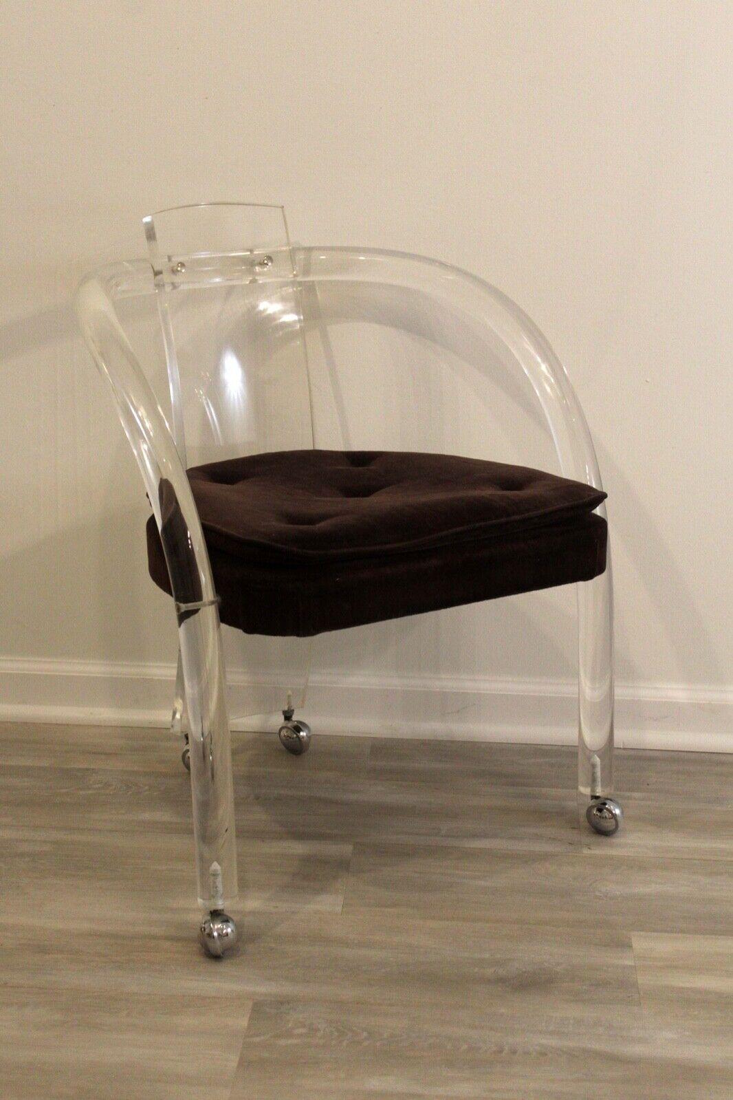 For your consideration is a truly tantalizing roller chair on wheels, made of tubular lucite with a velvet seat, in the style of Charles Hollis Jones. In excellent condition. Great accent or vanity chair. Dimensions: 23.5w x 19d x 29.5h Arm Height: