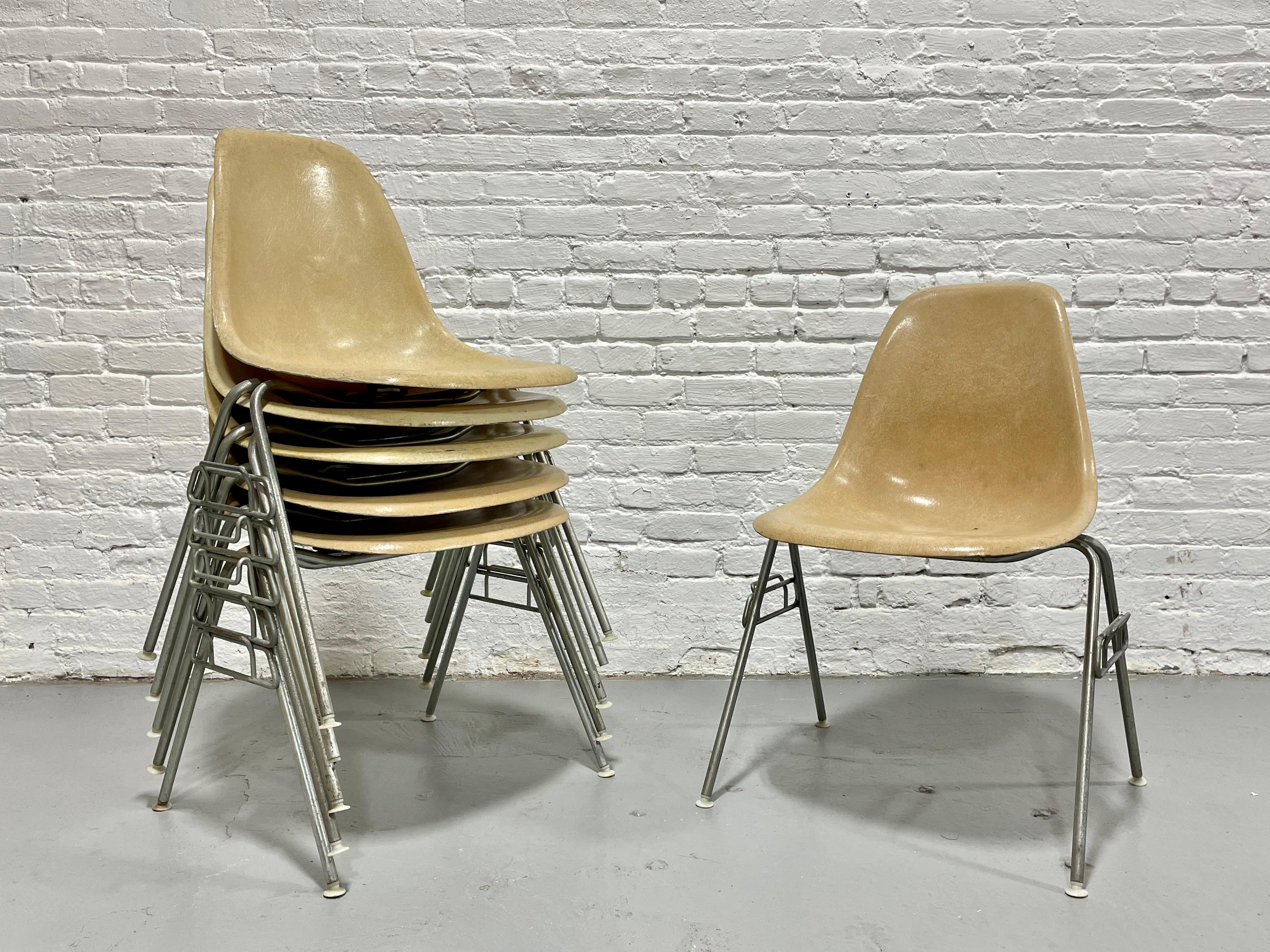 Mid Century Modern DSS stacking shell chairs designed by Charles and Ray Eames for Herman Miller in lovely neutral yellow / beige. Six available in total, two are lemon yellow and the others are yellow beige. Good vintage condition with some