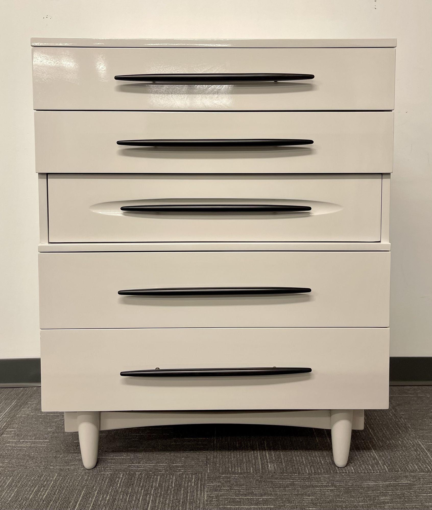Mid Century Modern Chest, Dresser, White Lacquered, Custom Made
This recently re-lacquered chest is in seemingly pristine condition. The five drawer high custom made, Harmony House, is simply stunning. The drawers each having wooden pulls inside of