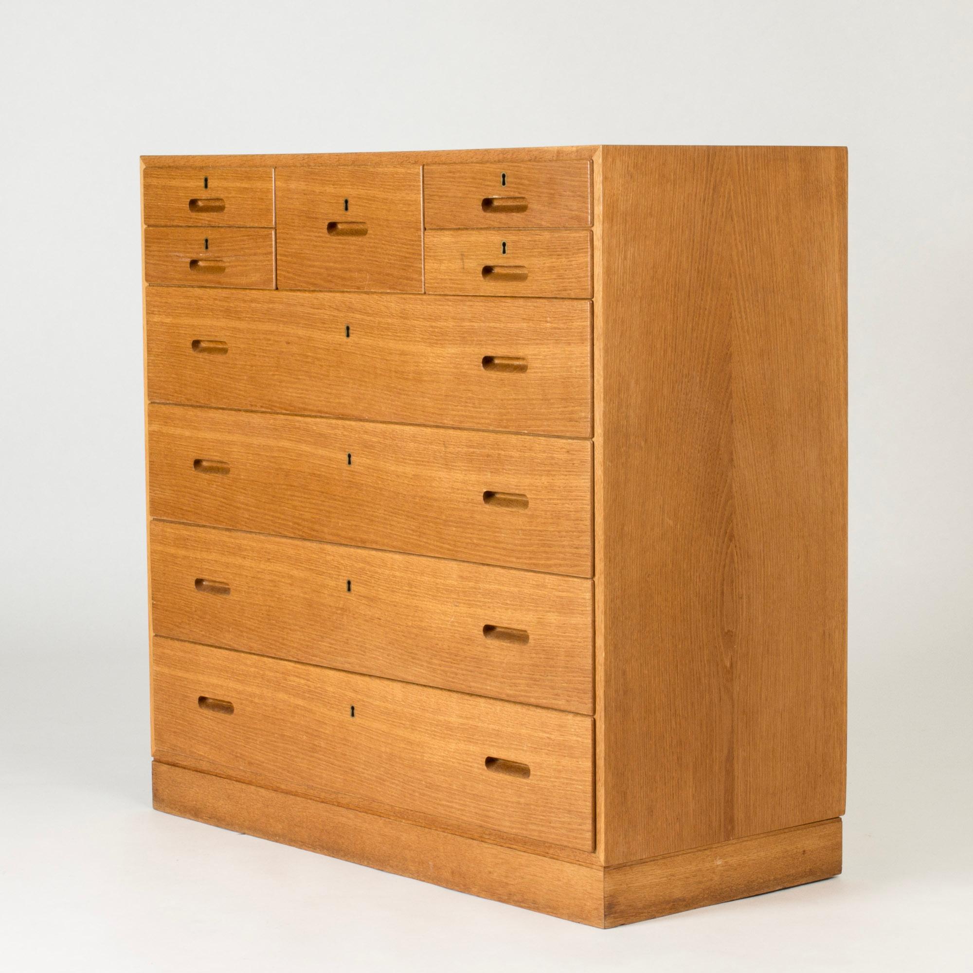 Cool chest of drawers by Kai Winding, made from oak in a lovely warm color. Large model with several drawers in different sizes, forming a cool pattern. Recessed drawer handles.