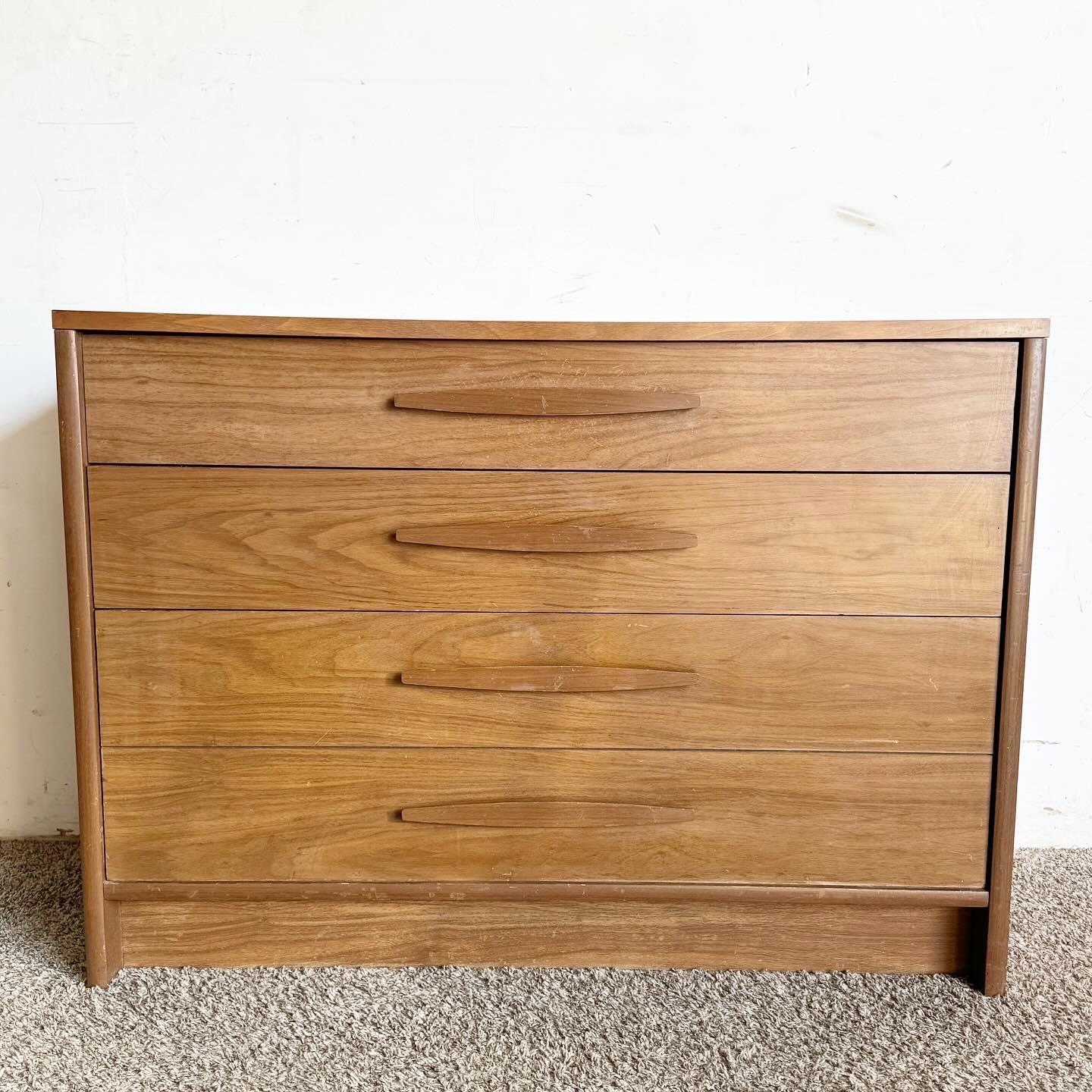 Discover the charm of the Mid Century Modern Chest of Drawers by Kroehler, a perfect blend of style and functionality. With its classic clean lines and minimalist aesthetic, this chest is a testament to mid-century modern design. Made from