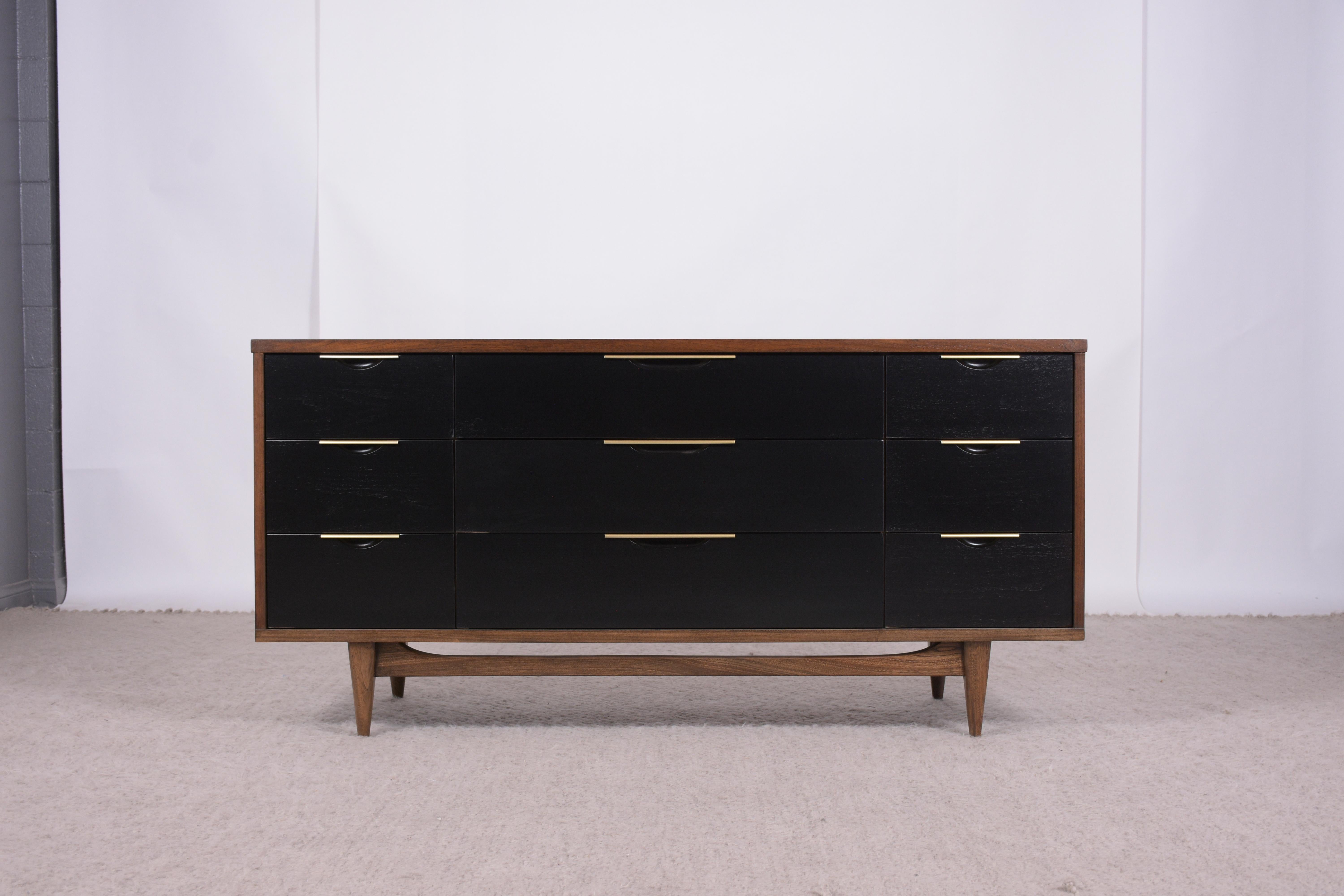 Discover the exceptional beauty of our Mid-Century Walnut Dresser, a masterpiece of craftsmanship and design, professionally restored to impeccable condition. Hand-crafted from high-quality walnut wood, this dresser is a stunning addition to any