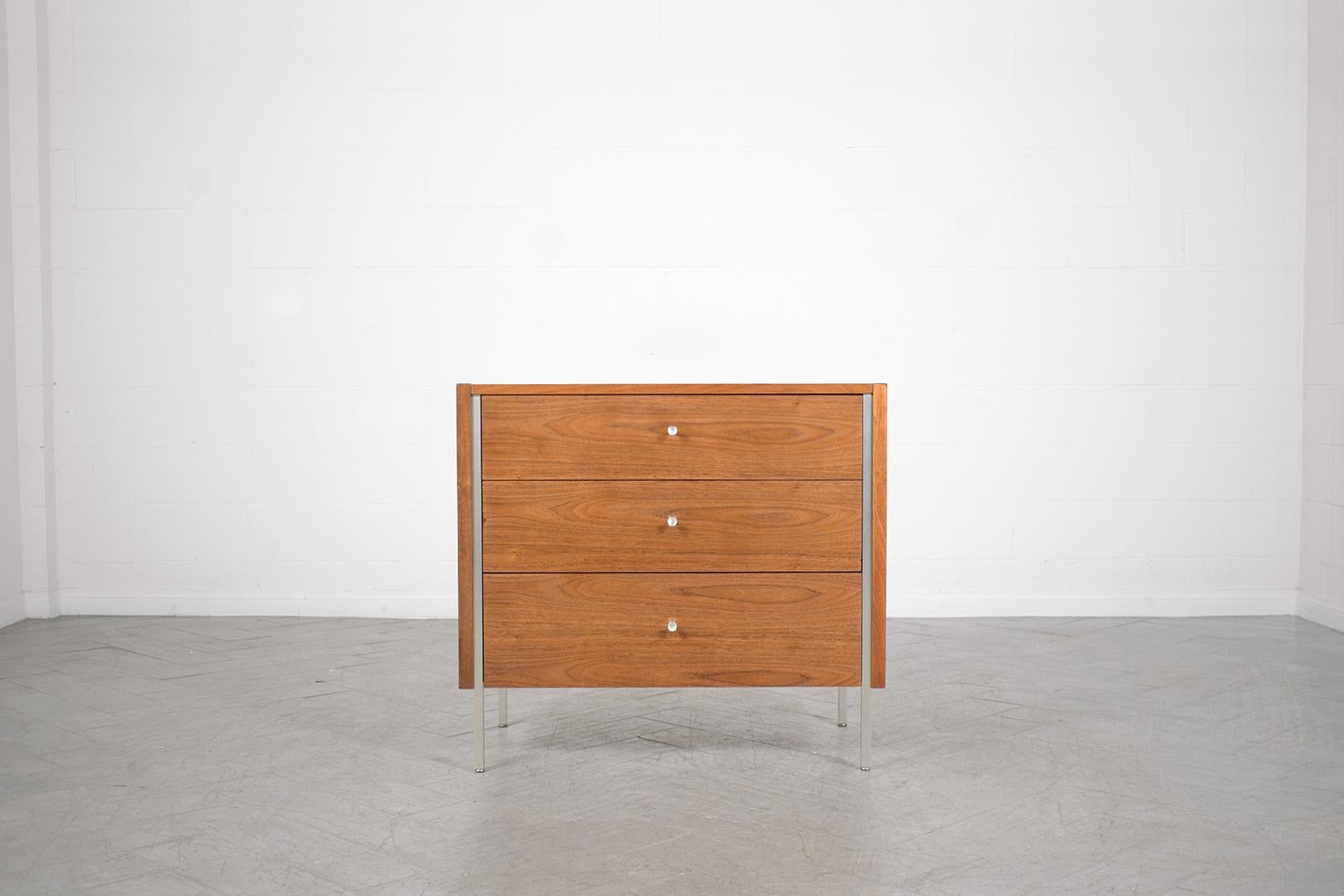 Delve into the realm of mid-century elegance with our meticulously handcrafted walnut chest of drawers, a piece that stands as a testament to skilled craftsmanship and timeless design. This dresser has been expertly restored by our dedicated