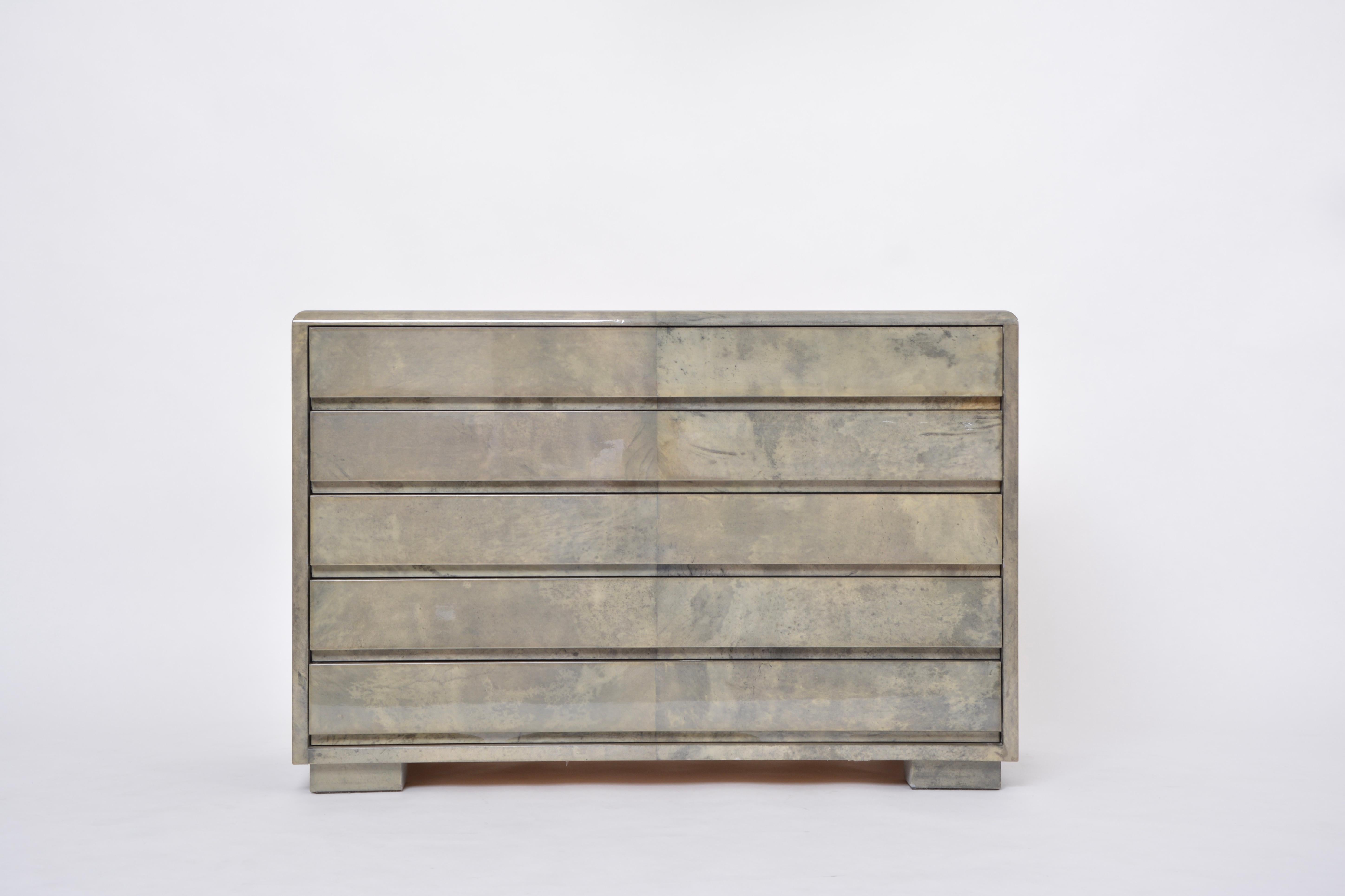 Mid-Century Modern Chest of drawers made of wood and laquered Goat Skin by Aldo Tura designed by Aldo Tura and produced in Italy approximately in the 1970s.
This chest of drawers has a wooden structure which is covered in Aldo Tura's signature style