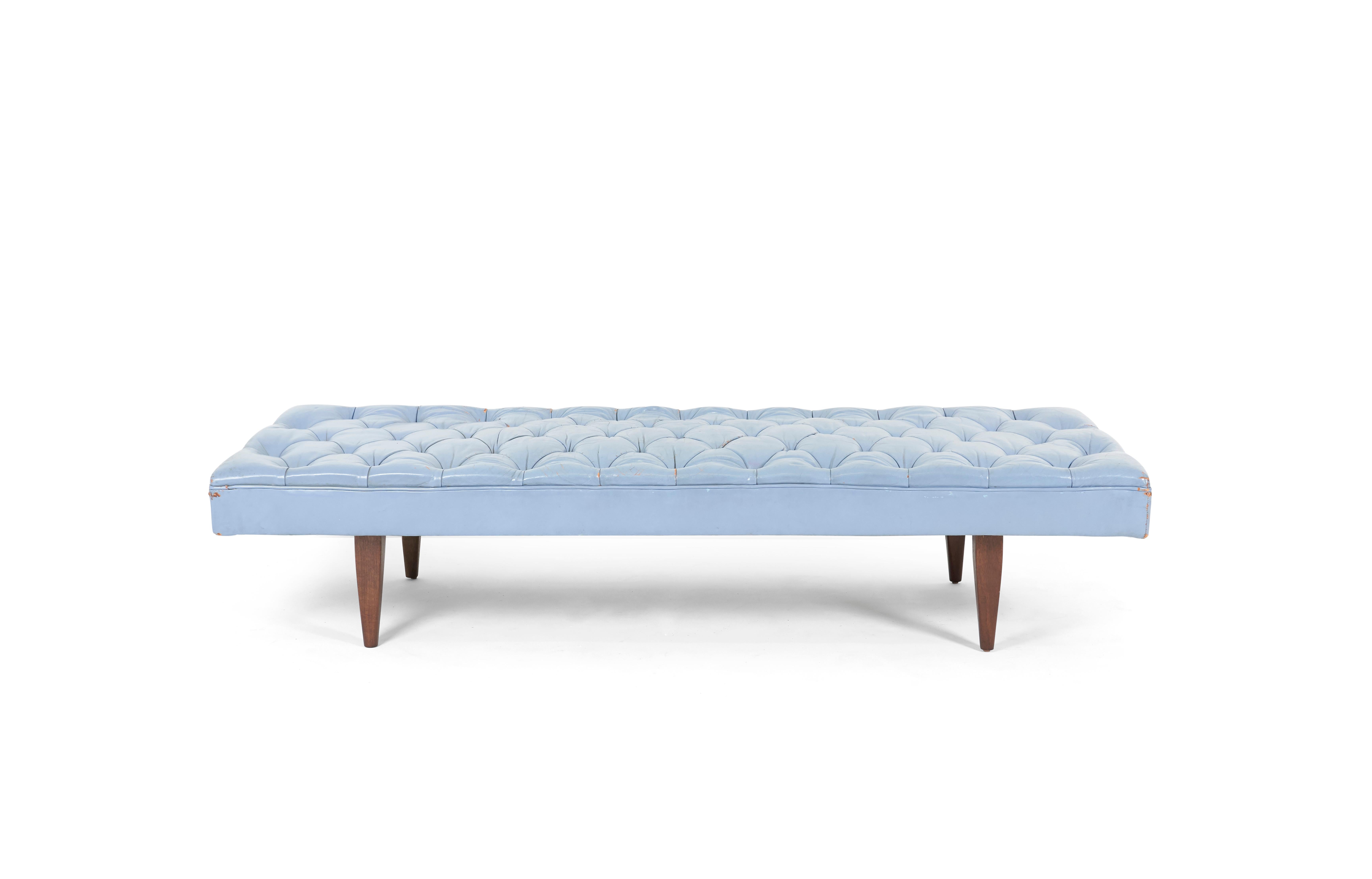 Chesterfield tufted daybed bench. Designed by Kipp Stewart for Calvin Furniture. Original tufted blue leather has great broken-in patina. Walnut legs have been refinished, cushion support strapping replace.