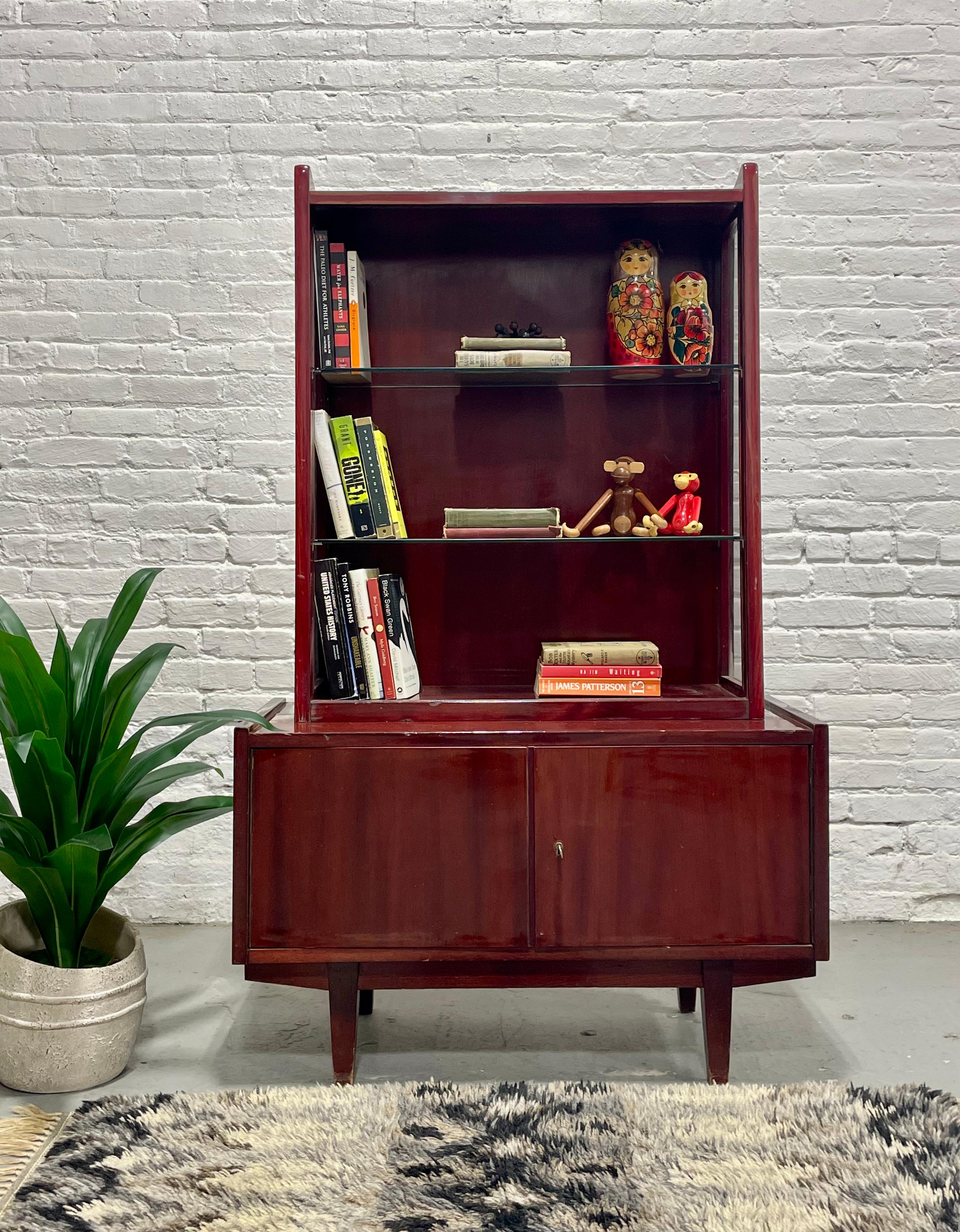 Mid Century Modern China Cabinet / Bookcase by Rajmund Halas for Jarocinska, Made in Poland, c. 1960’s. This two piece cabinet offers plenty of storage space with two glass shelves above and an open storage space in the lower credenza. The glass