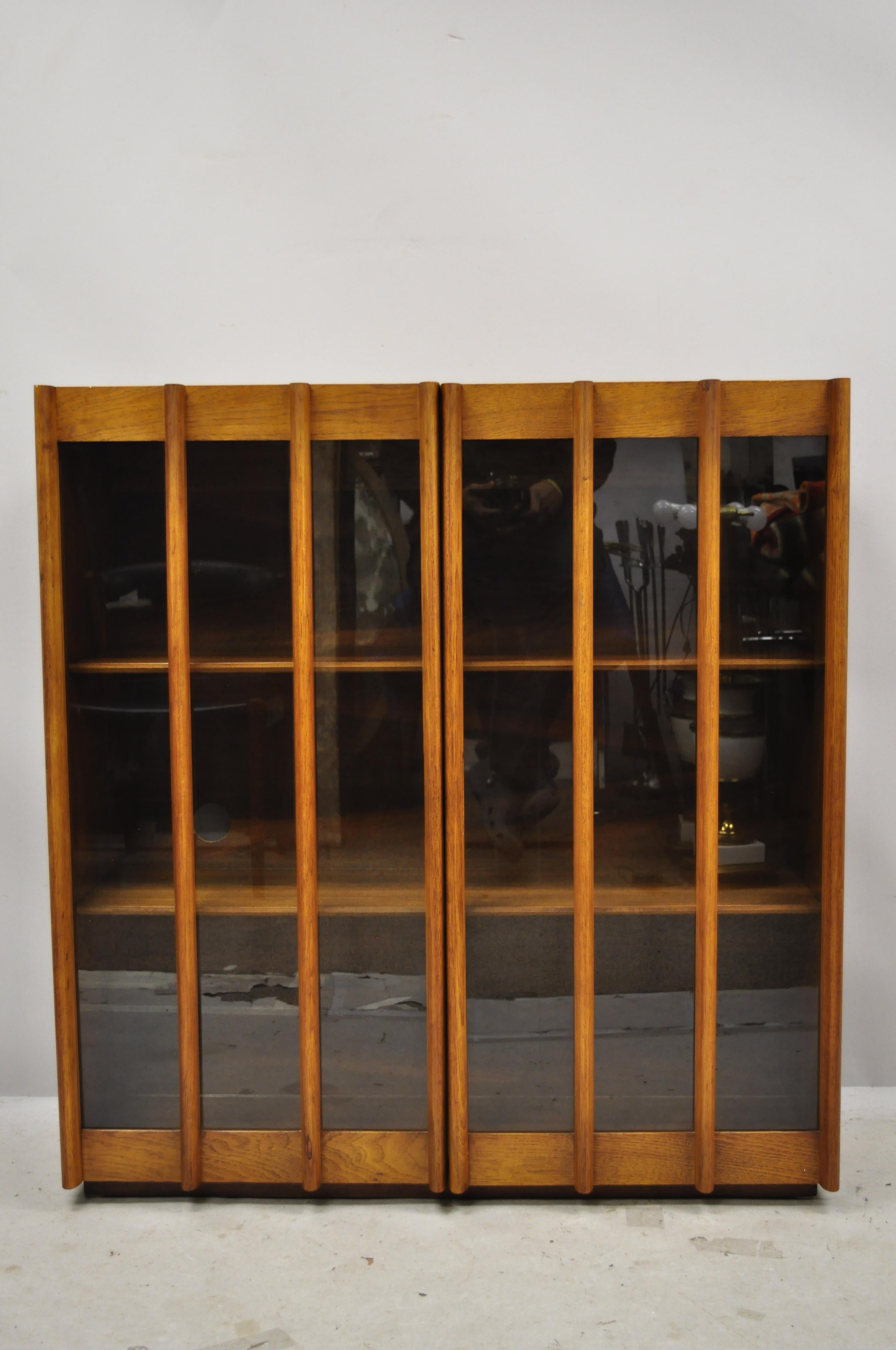 Mid-Century Modern China cabinet bookcase hutch top sculptural walnut with glass doors. Item features beautiful wood grain, nicely carved details, 2 glass swing doors, 2 adjustable wooden shelves, clean modernist lines, sleek sculptural form. Note: