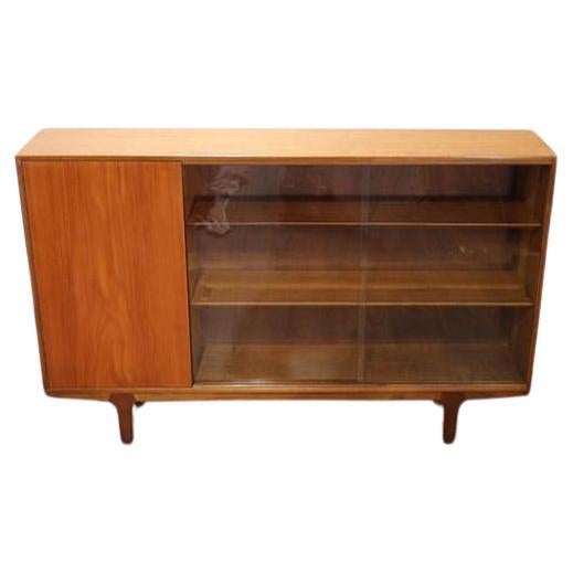 A beautiful mid century china display cabinet made by Mcintosh of Scotland. This gorgeous cabinet sat sculpted legs is a real head turner. With sliding glass doors and adjustable shelves, there is plenty of display space. Ideal for showcasing your