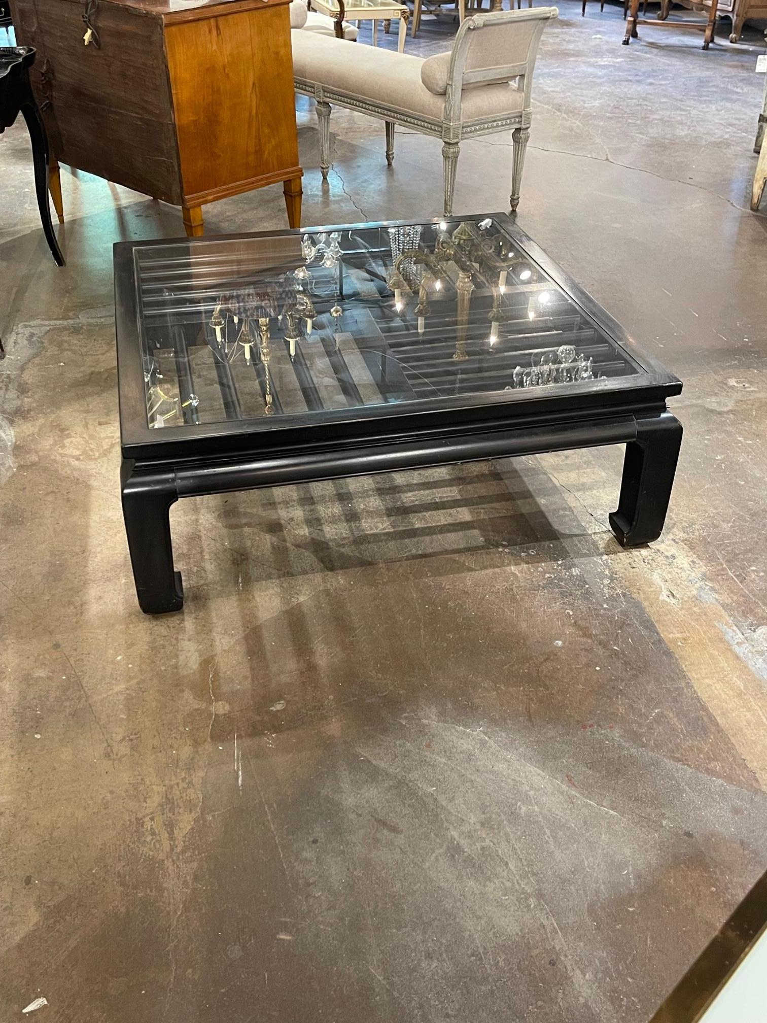 Handsome Mid-Century Modern square shaped ebonized coffee table with bar pattern and a glass top. Very fine quality and great for a variety of decors!