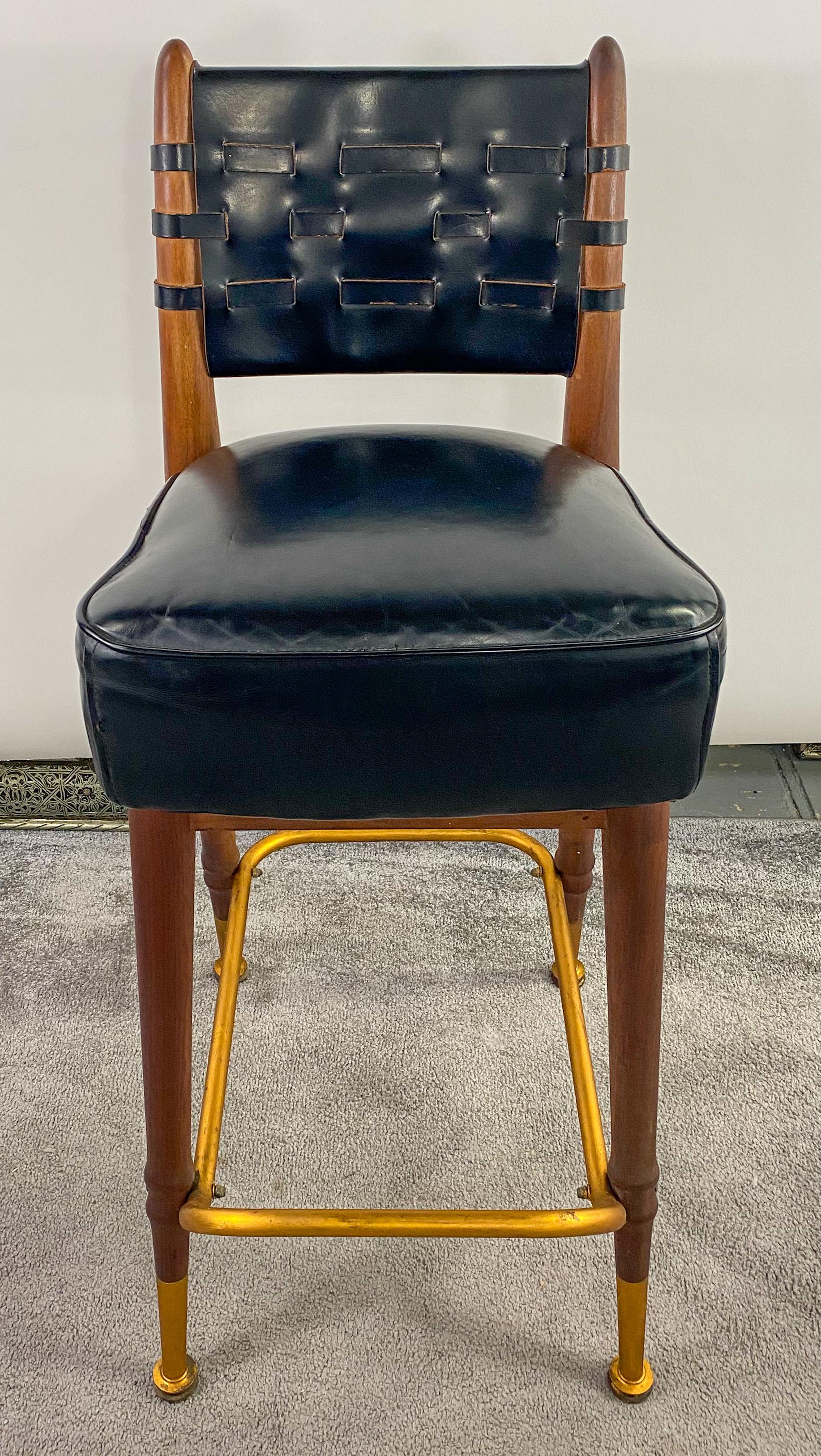 A high quality Mid-Century Modern set of three high bar or counter stools made and designed by the Chairmasters Inc in New York. The elegant stools are study and made of high quality black leather with the stool back having a webbed design and the