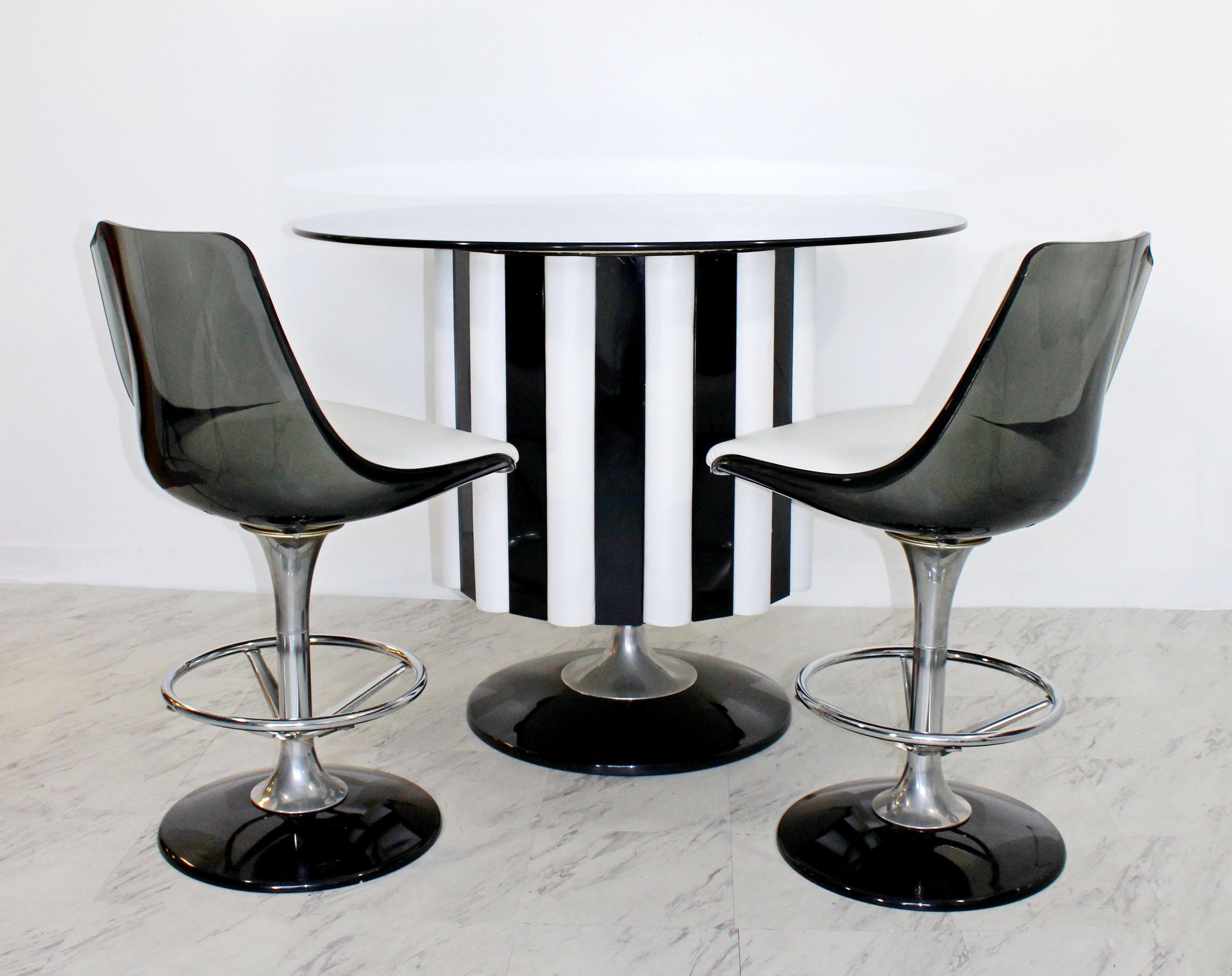 For your consideration is a magnificent dry bar, and pair of matching stools by Chromcraft, circa the 1970s. The bar is made of chrome & vinyl, with a smoked glass, kidney shaped top, and the chairs are chrome & smoked lucite. In very good