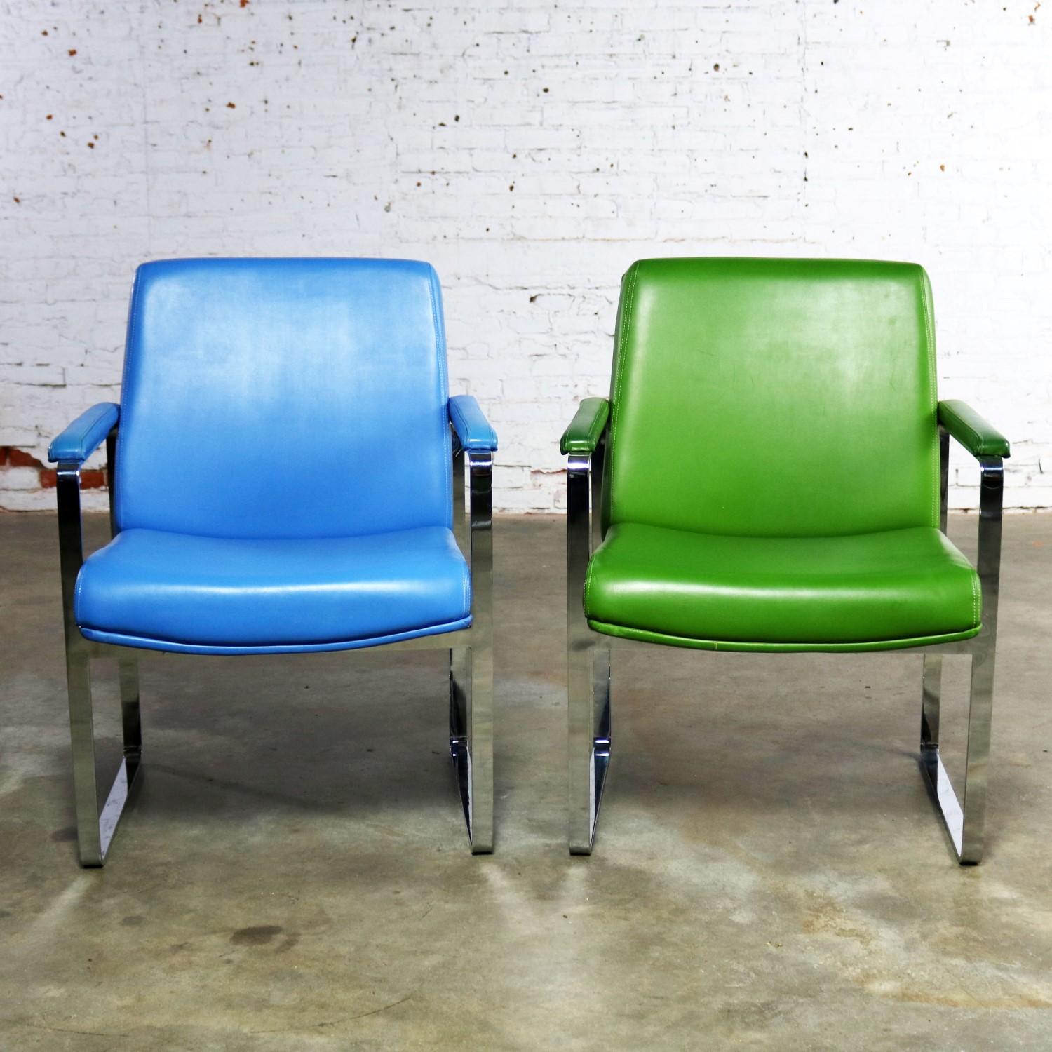 Wonderful Chromcraft Mid-Century Modern flat-bar chromed steel chairs one in cornflower blue vinyl and one in grass green vinyl. The chrome is in fabulous condition. The vinyl upholstery is in wonderful condition apart from several small nicks that