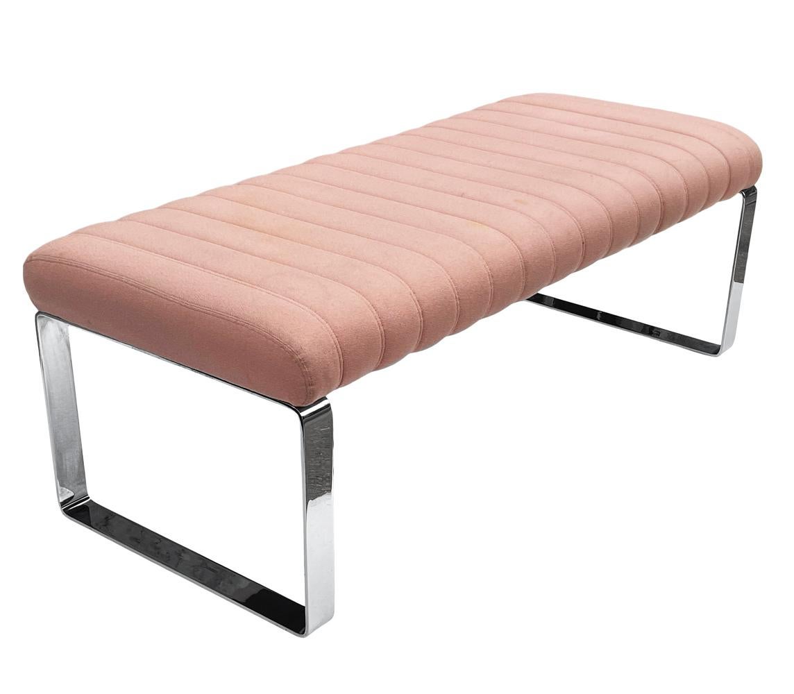 Sleek & heavy bench circa 1970's. Solid chrome flat bar legs with original blush upholstery. Fabric is original and could use replacing. Foam and padding are very soft.