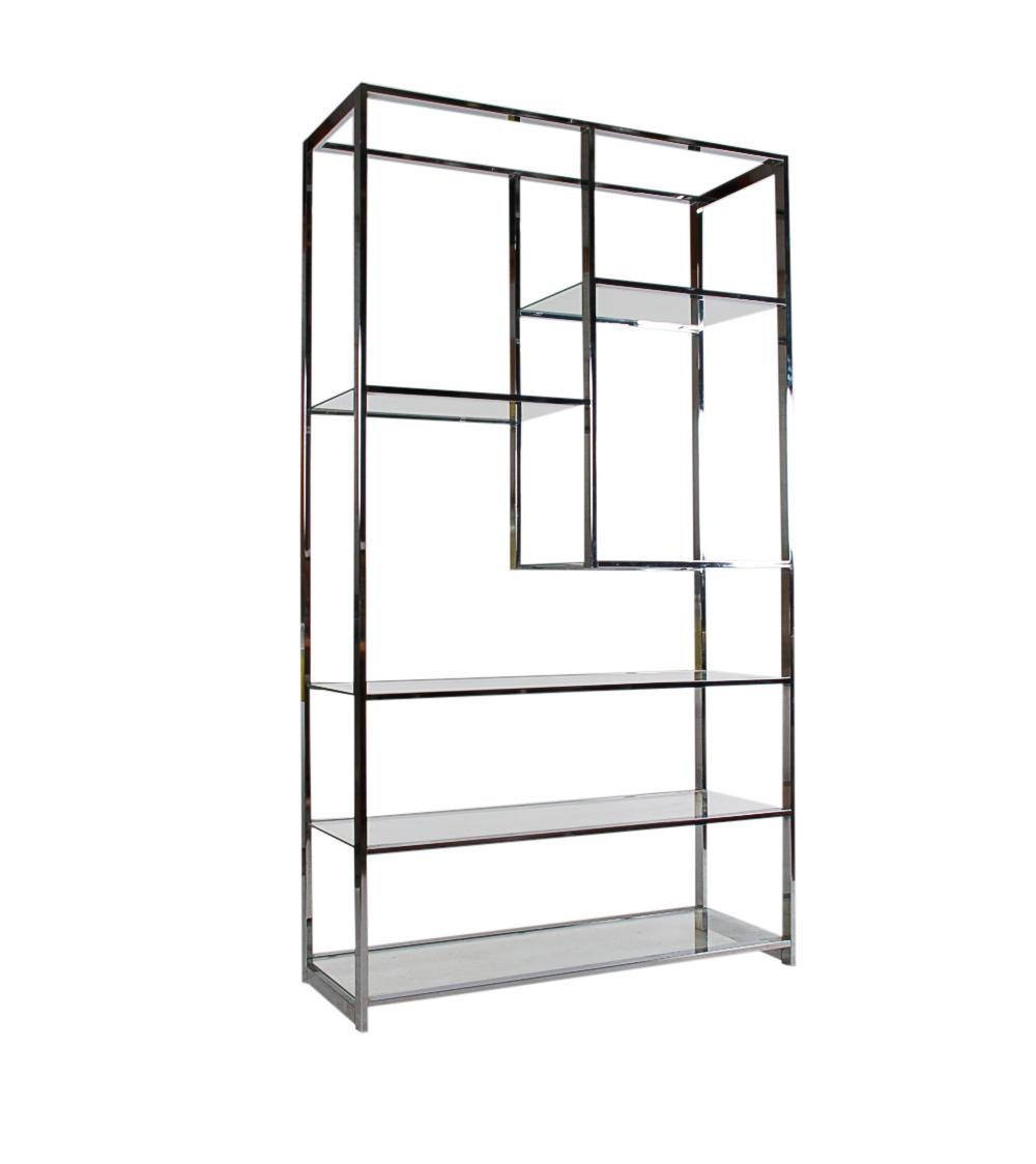 A Classic 1970s design in the style of Milo Baughman. This étagère features a chrome-plated steel construction with inlayed glass shelving. In beautiful well cared for condition.