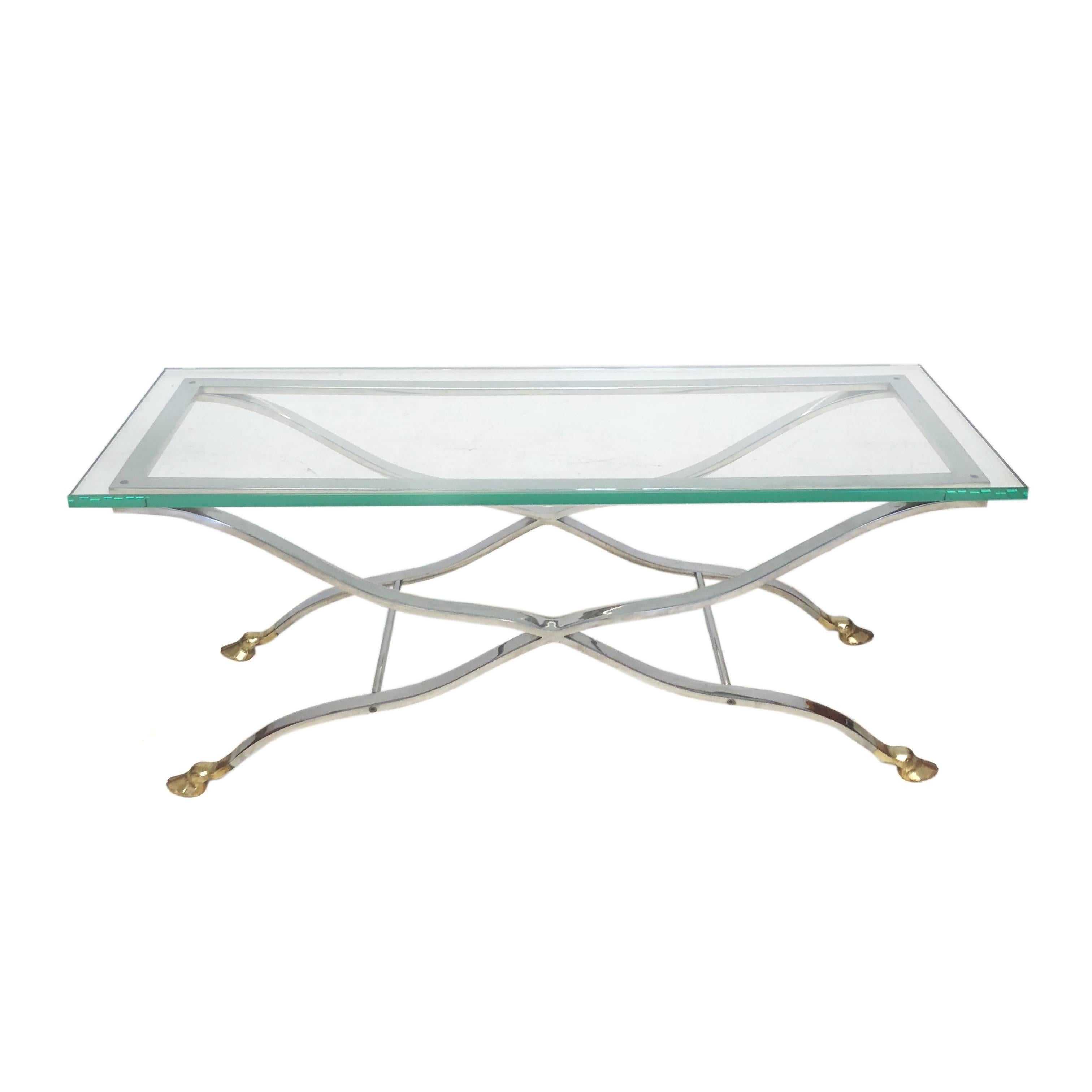 Mid-Century Modern highly polished chrome and glass coffee table or console with brass hoof feet. Age appropriate wear.

Measurements:
Overall: 46