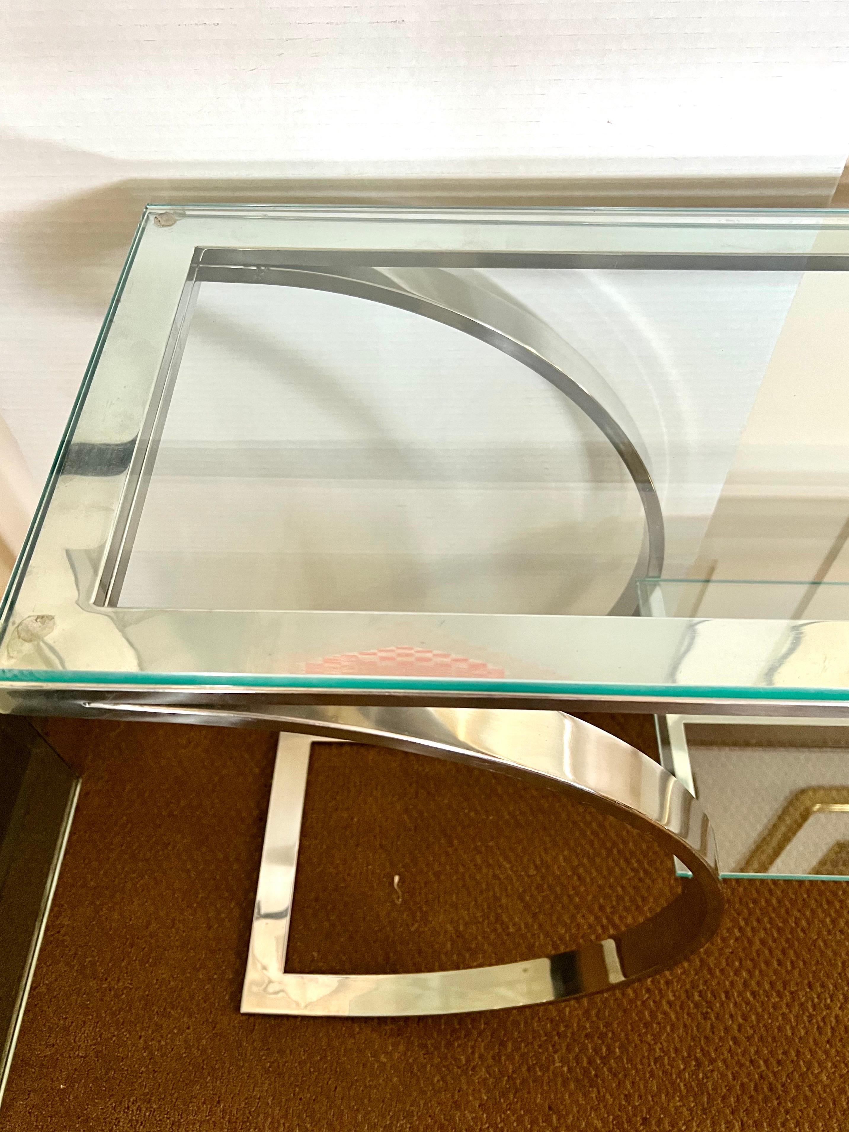 Elegant Mid-Century Modern two level glass and chrome console table in the manner of Milo Baughman. Features two levels of glass and curved chrome.
Why not own the best?.