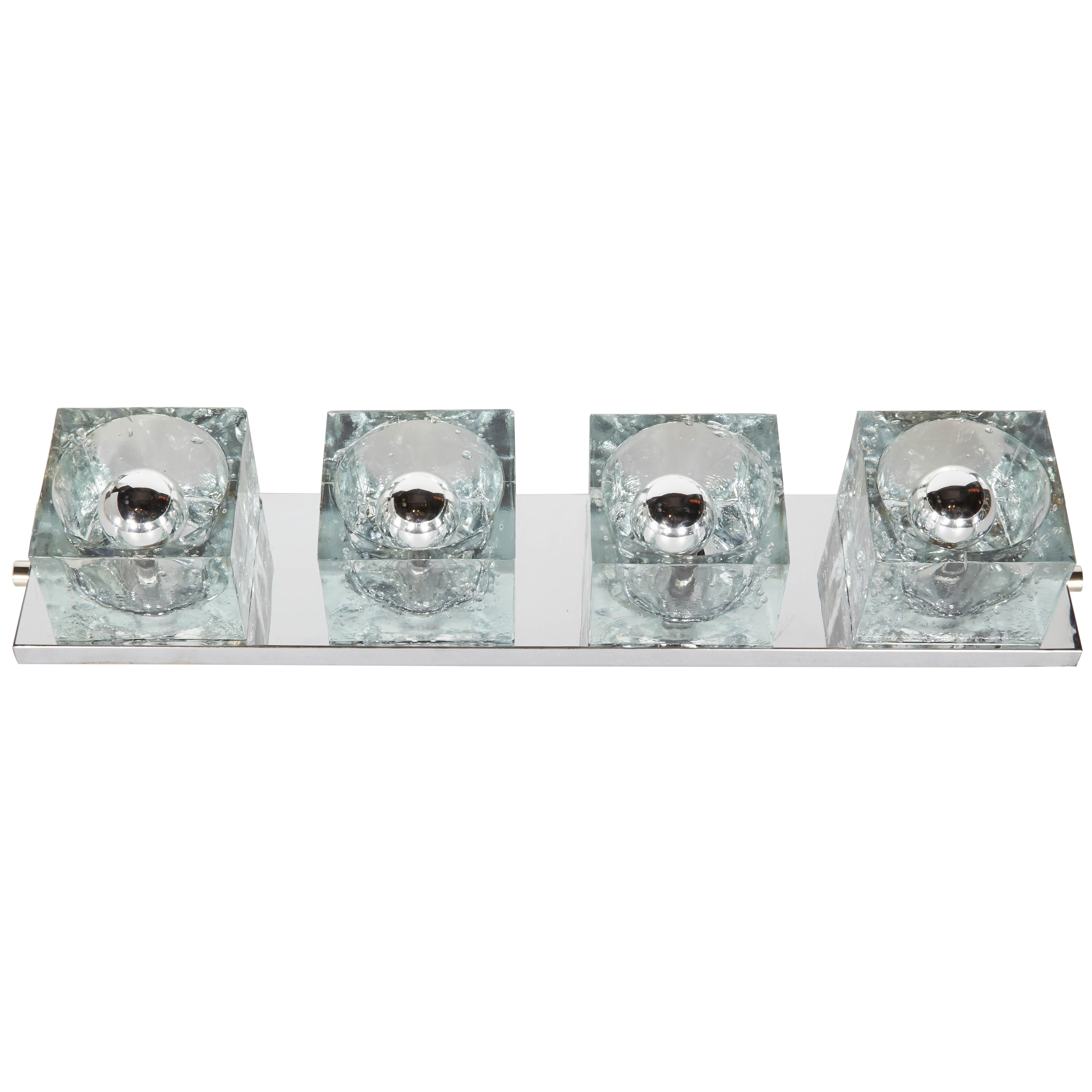 Cubist wall sconce featuring four large chunky glass block shades. Streamline polished chrome frame with cube glass design. Can be mounted vertically or horizontally.  Shown with chrome tip bulbs. 

Minor wear on frame and some glass components have