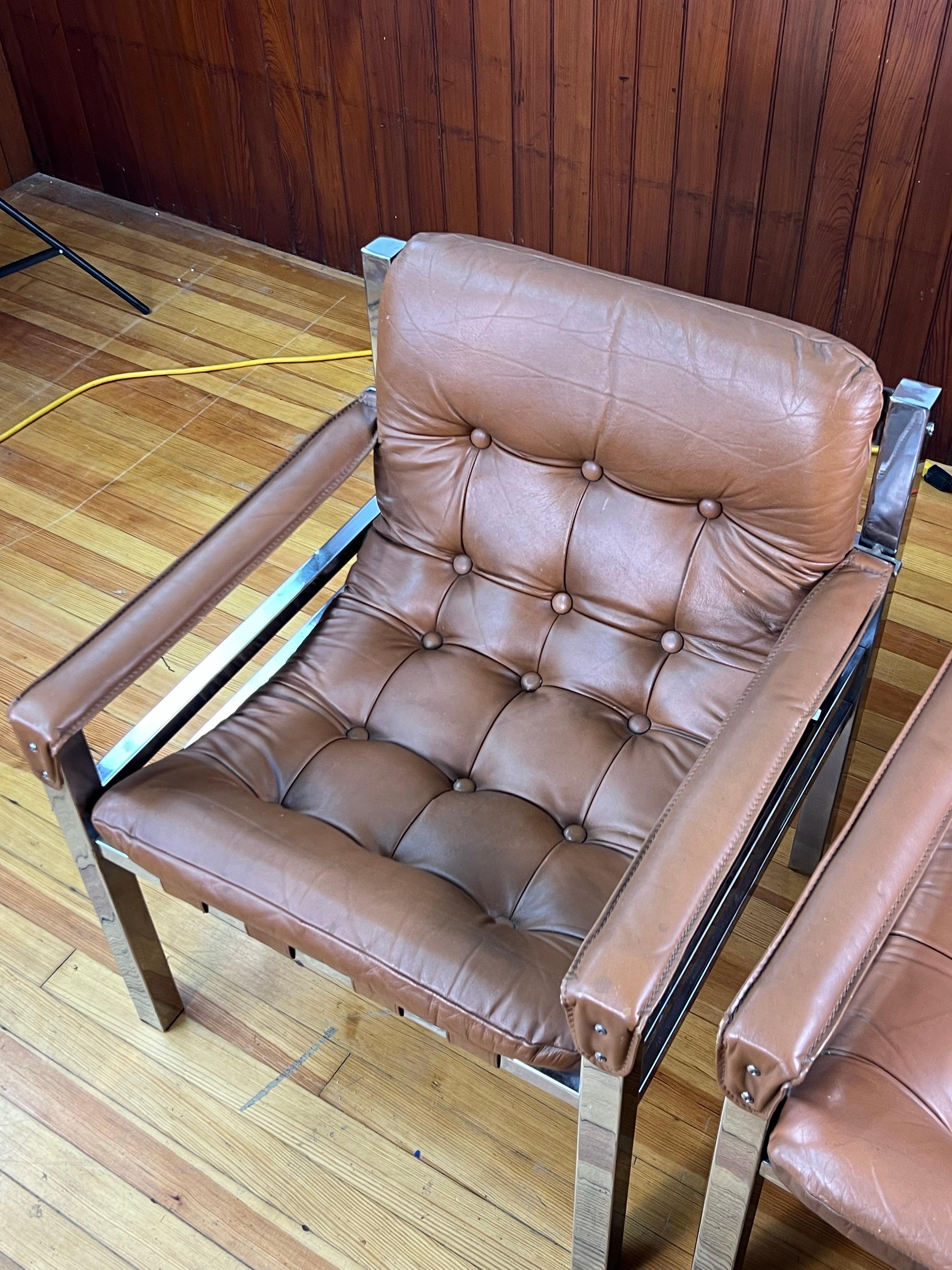 Este es un magnífico conjunto único de sillones Safari vintage de mediados de siglo, cromados y de cuero. Son muy poco habituales y resultan muy cómodos.