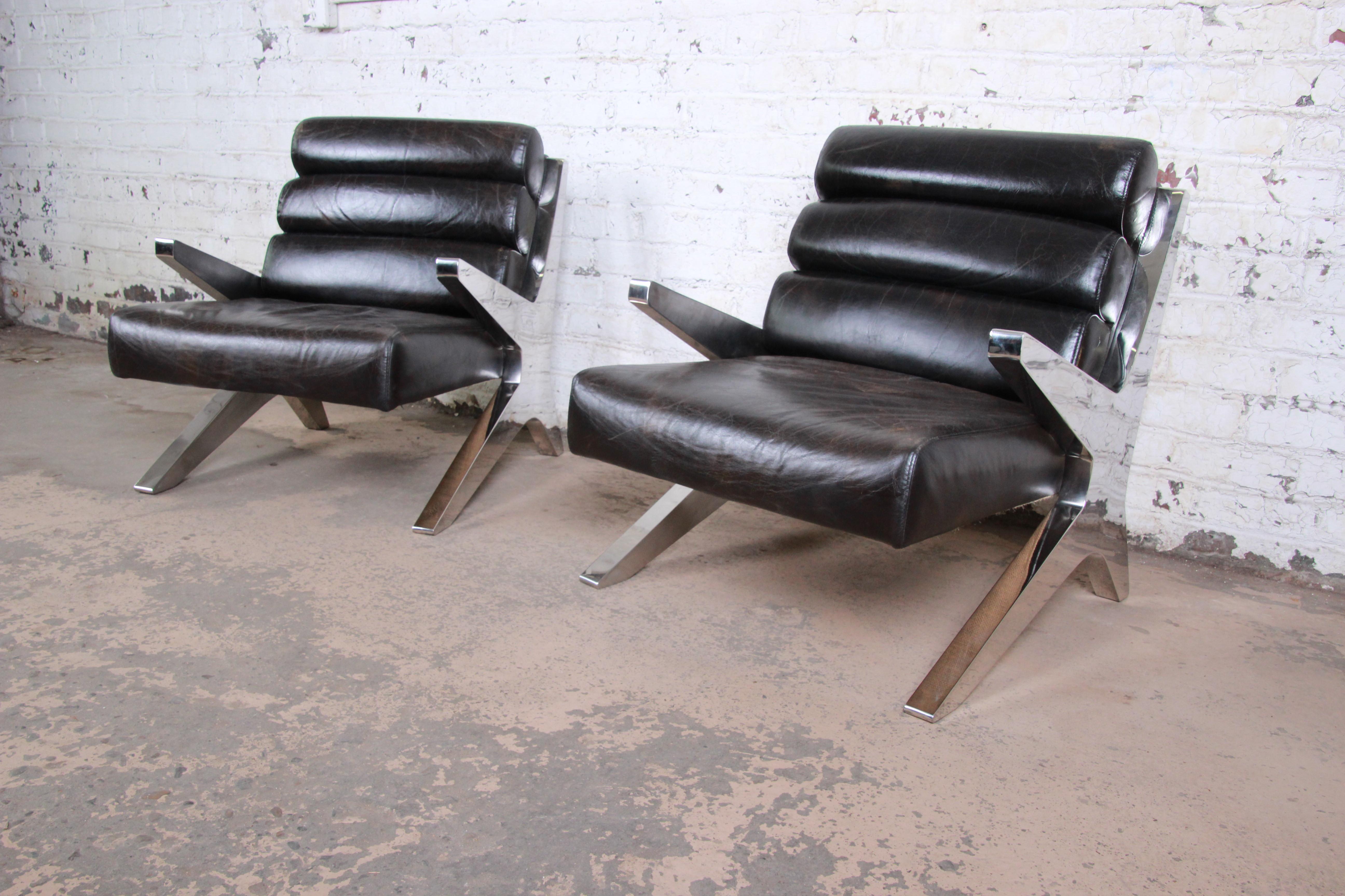 An outstanding pair of Mid-Century Modern lounge chairs, circa 1970s. The chairs feature stunning chrome frames in a scissor form and high grade dark brown leather. True statement pieces for any modern or Mid-Century Modern environment. The chairs