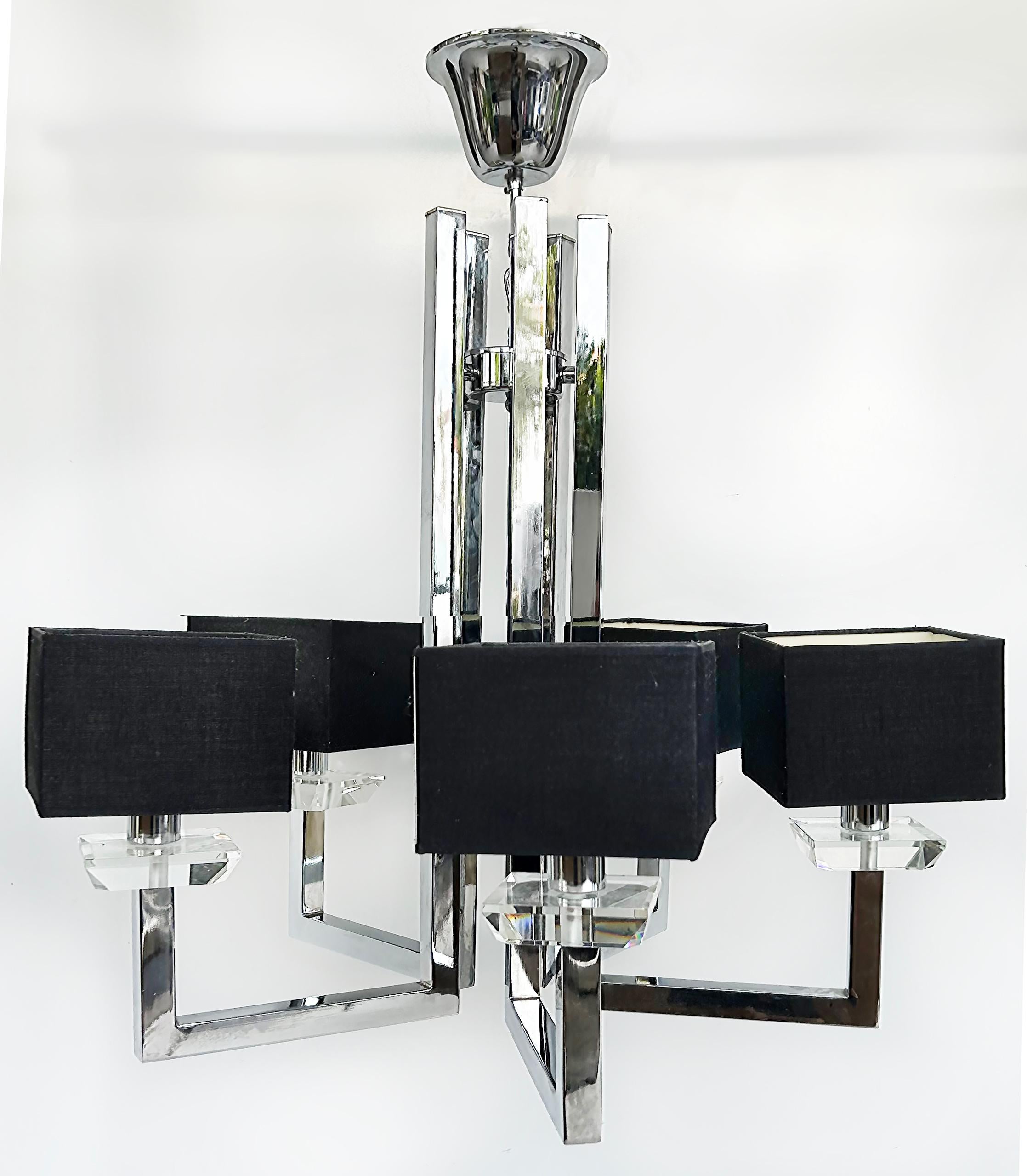 Mid-century Modern Chrome and Lucite 5 Arm Chandelier with Square Shades

Offered for sale is a mid-century modern chrome and lucite five-arm chandelier with square black fabric shades.  The chandelier is wired and in working condition and each arm