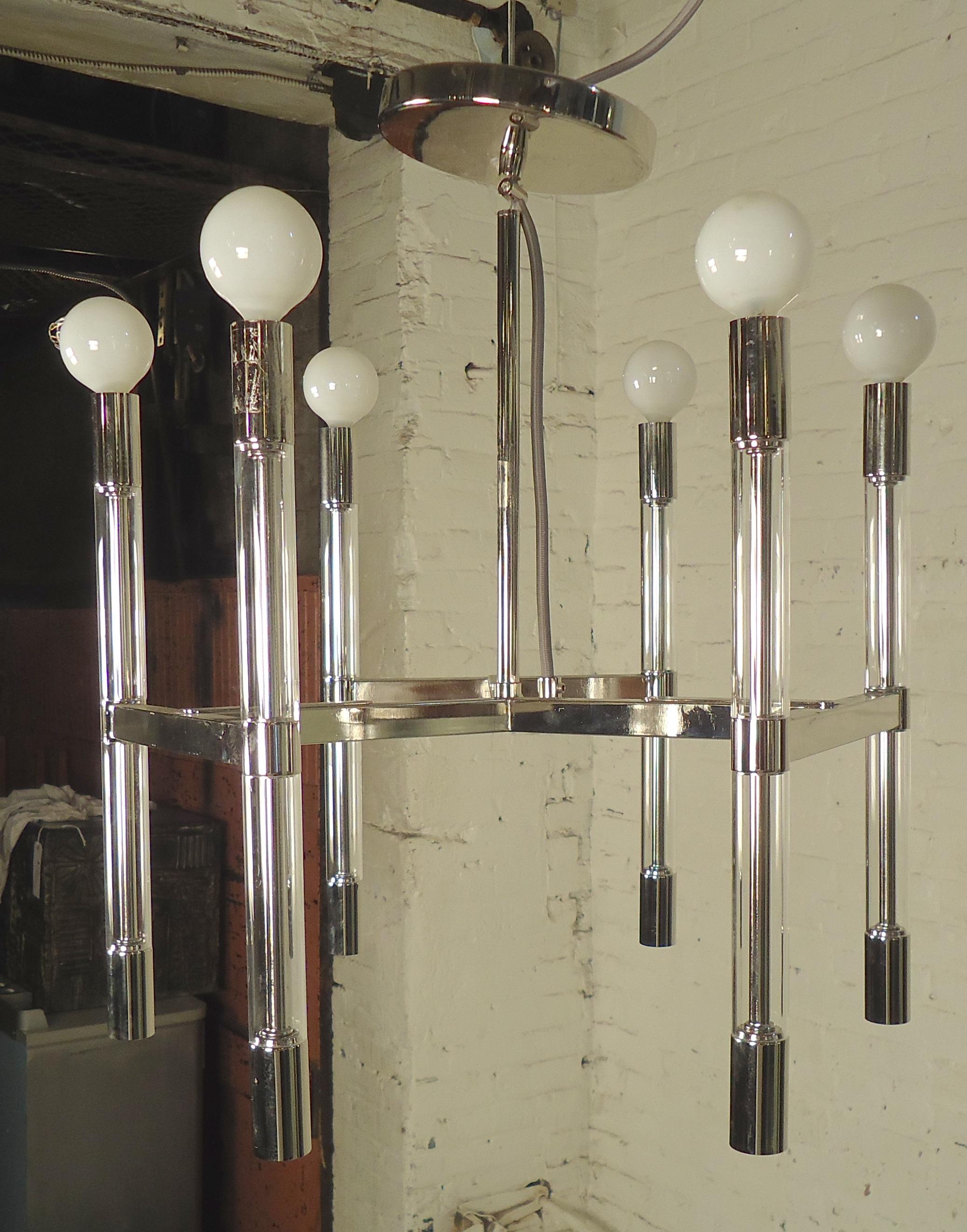 Sleek modern style chandelier with up and down lighting. Chrome framing with clear Lucite accents. Twelve total sockets.

(Please confirm item location - NY or NJ - with dealer).
 