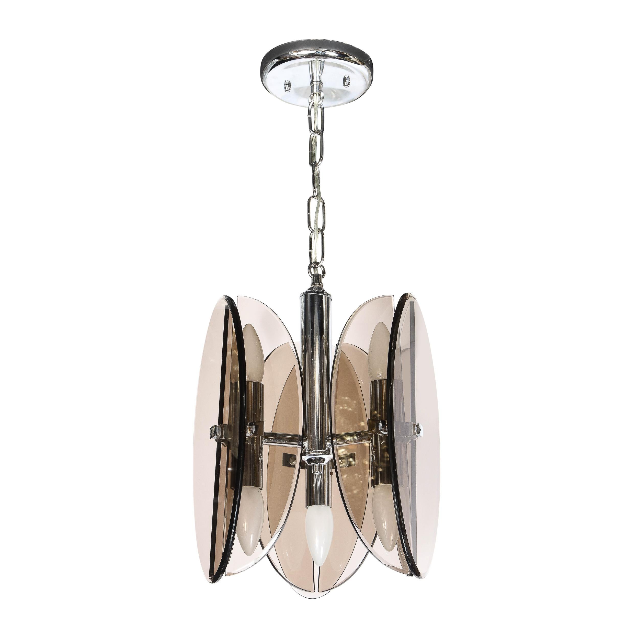 This stunning Mid-Century Modern pendant in the manner of Fontana Arte in Italy, circa 1960. It features a cylindrical body with a contracting conical top threaded with chain that connects to a circular canopy- all in lustrous chrome. Three arms